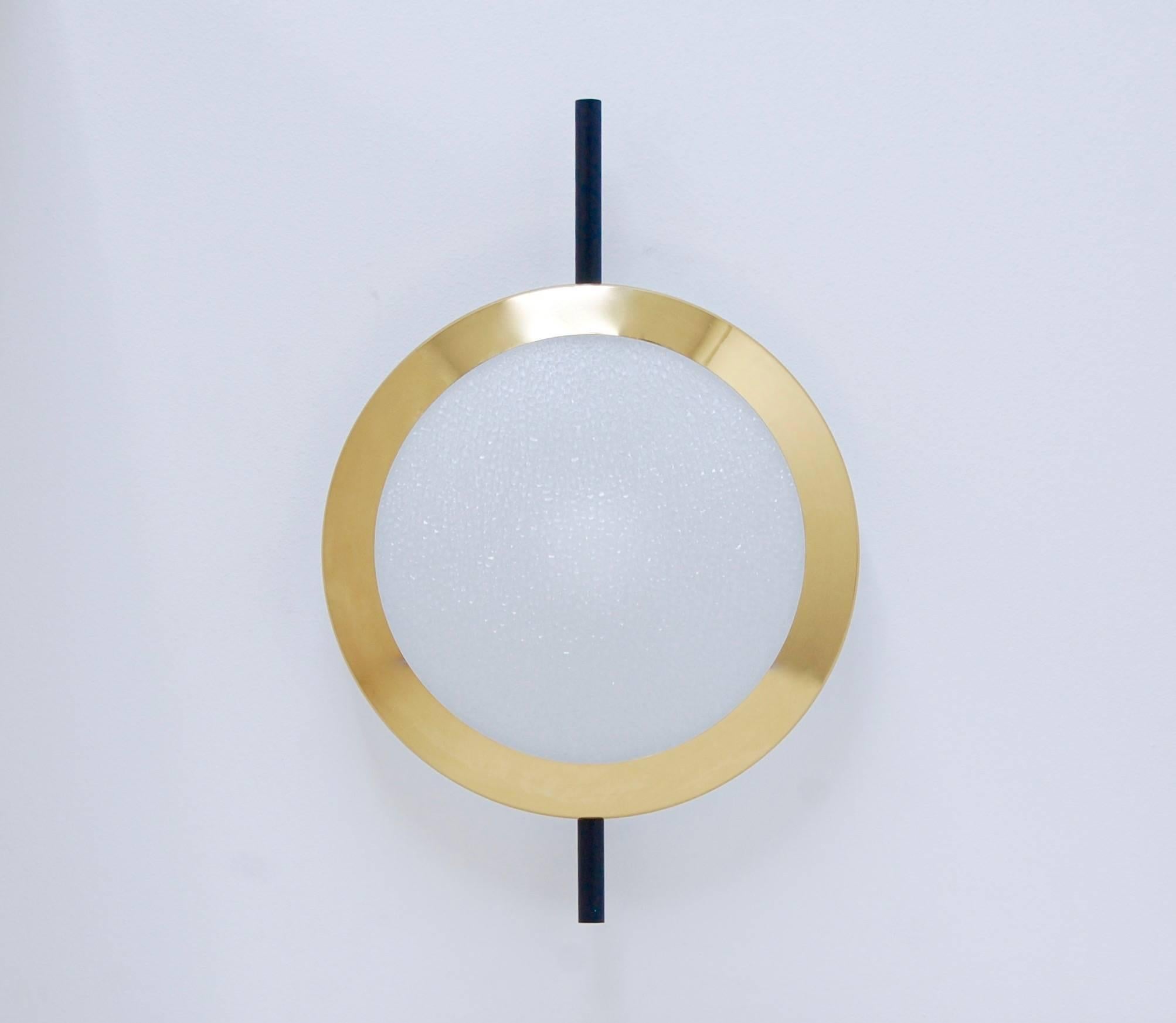 “Modern Eye”. Stunning brass and textured glass sconces in the manner of Stilnovo. Part of our contemporary collection, contact us for availability and lead time. Fabricated with brass, steel, aluminum and statinated, textured glass.