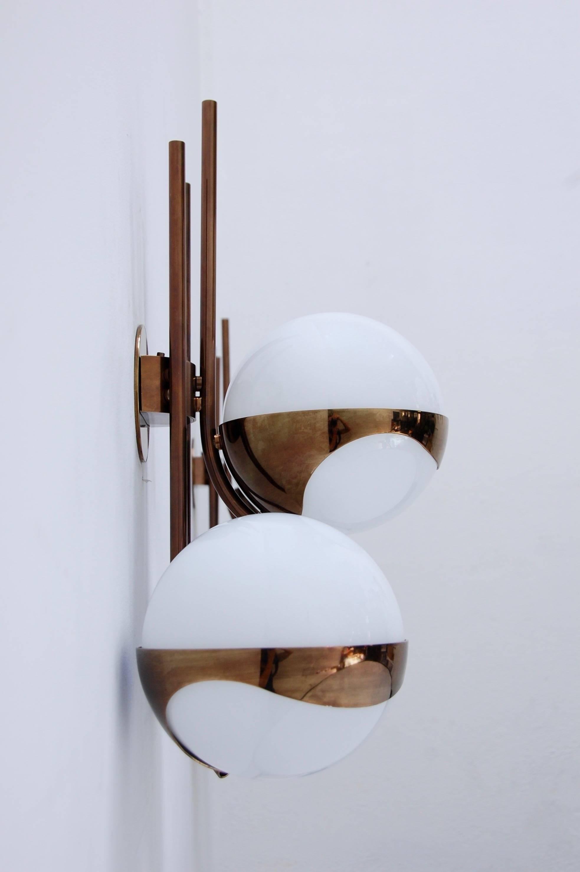 Beautiful rare pair of towering Lamperti wall sconces with three handblown glass globe shades from 1960s, Italy.