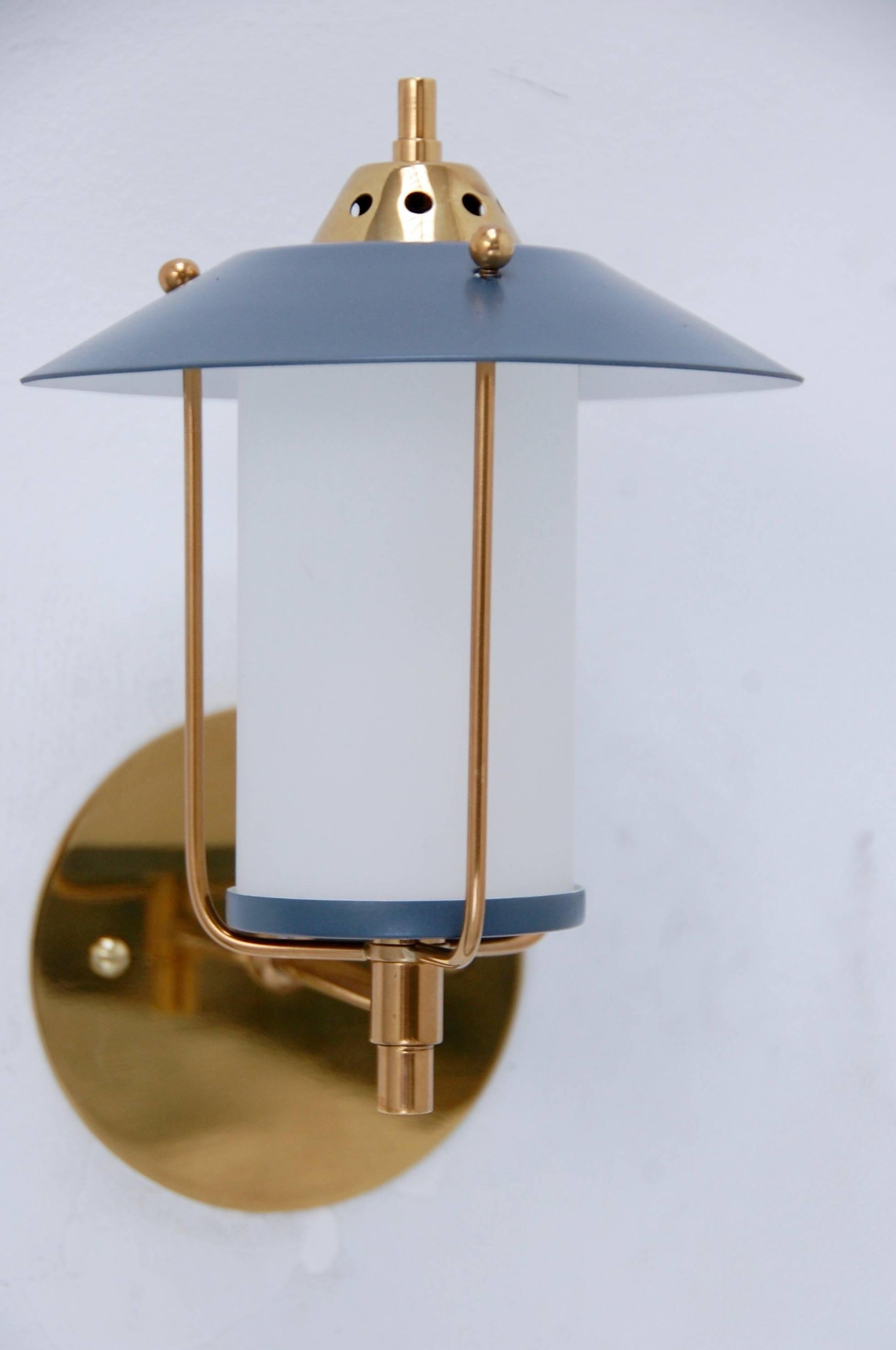 Pair of stylish petite lantern sconces in brass, painted aluminum and blown glass from Mid-Century Italy. Can be used either indoor or outdoor under an overhang. Single candelabra based socket per sconce.