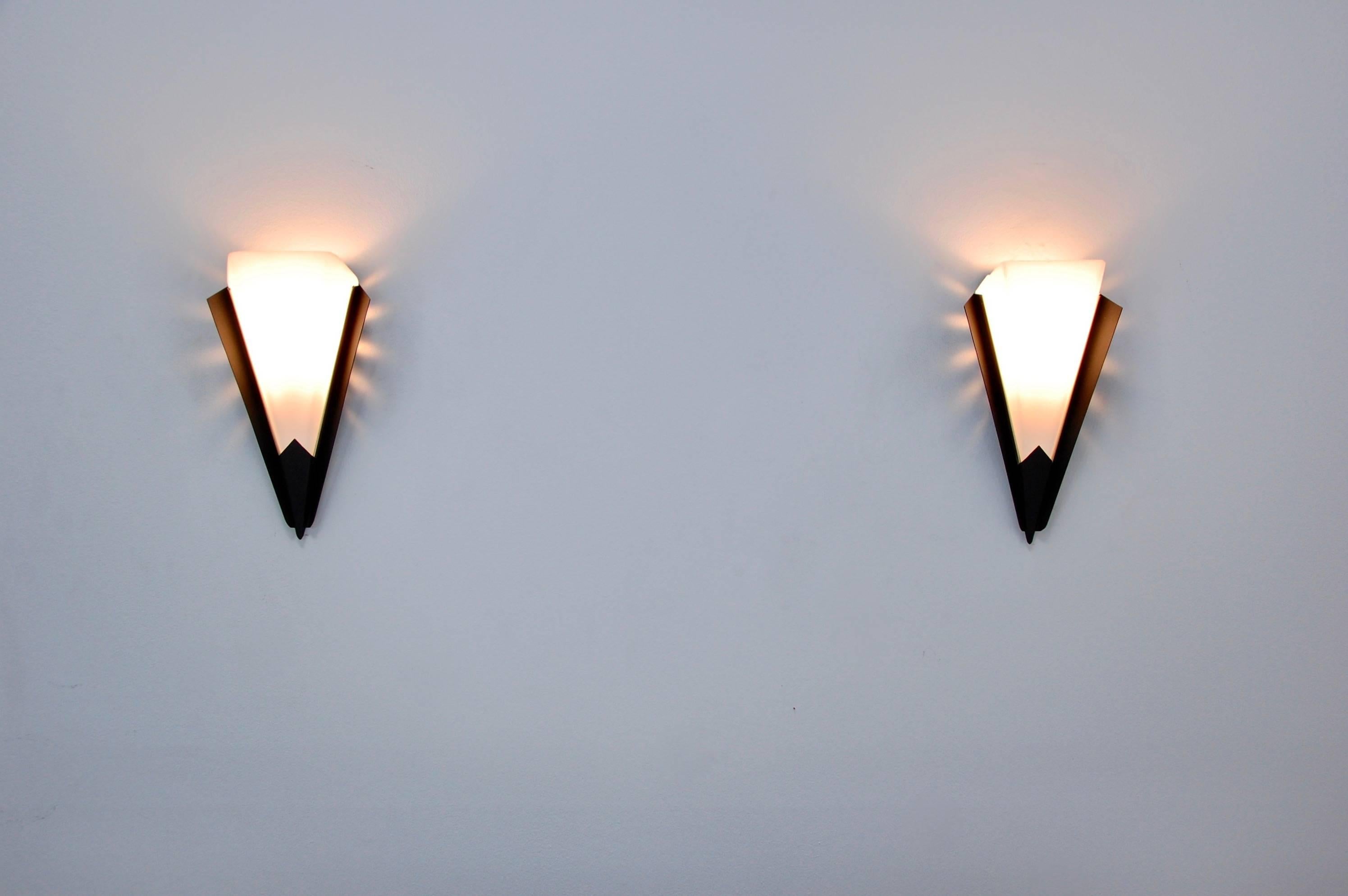 Pair of modern triangular perforated sconces from France.