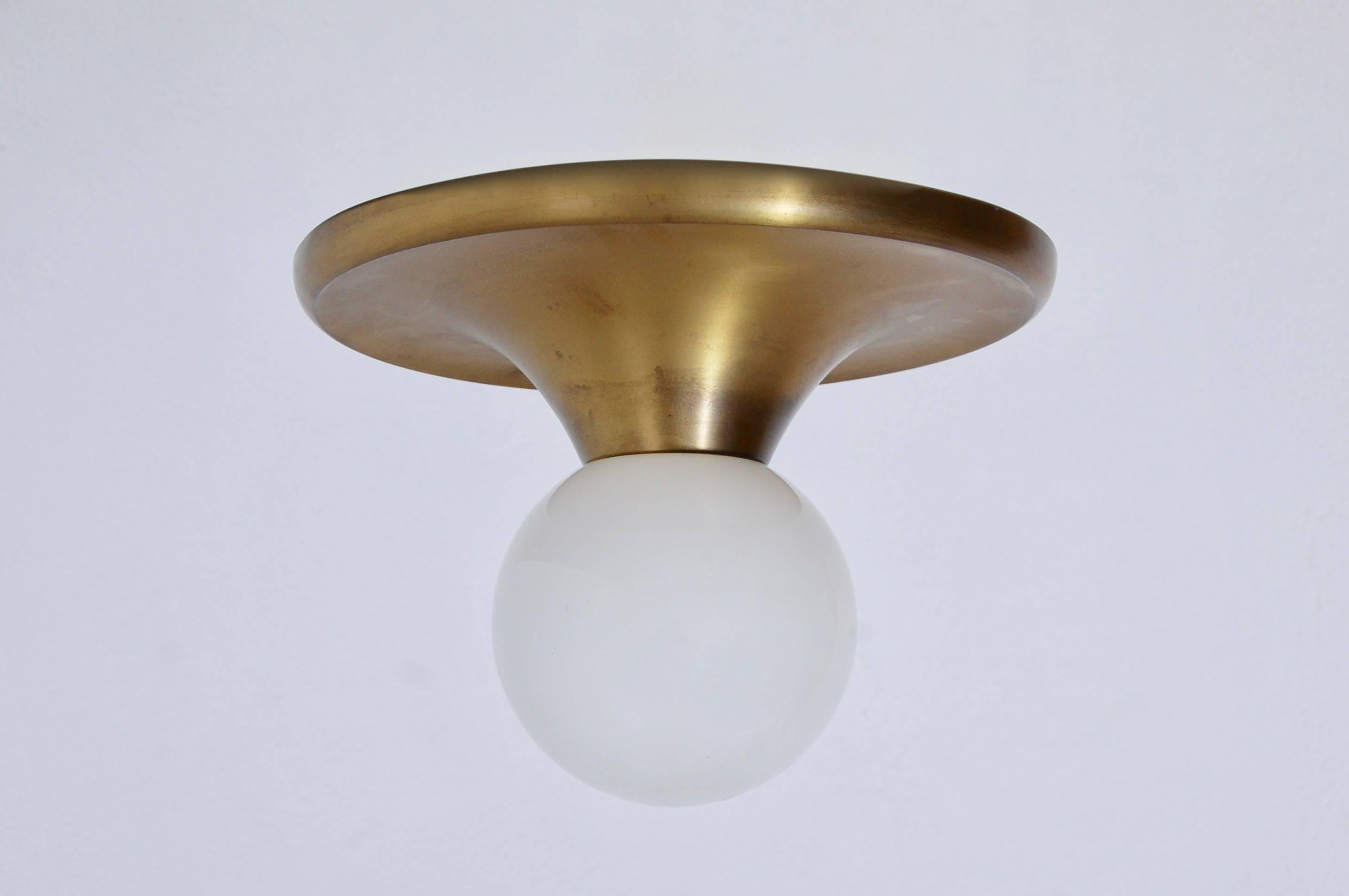 Light Ball Lamp by: Achille & Pier Giacomo Castiglioni

Classic 50s Italian flush or wall mount light fixture in patinated brass and glass. Wired for use in the USA with an E-26 medium based socket. Light bulb supplied with order.