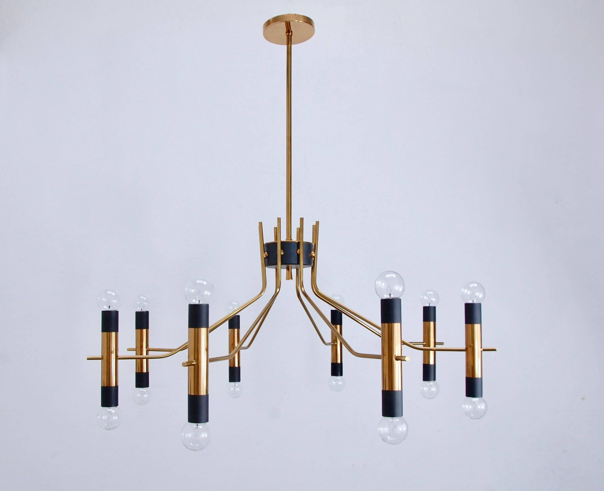 Stunning expansive 16 light brass Italian chandelier by Oscar Torlasco from Mid-Century Italy. Total overall drop adjustable upon request.
Measures: Height: 35” with bulbs.
Diameter: 38”.
   