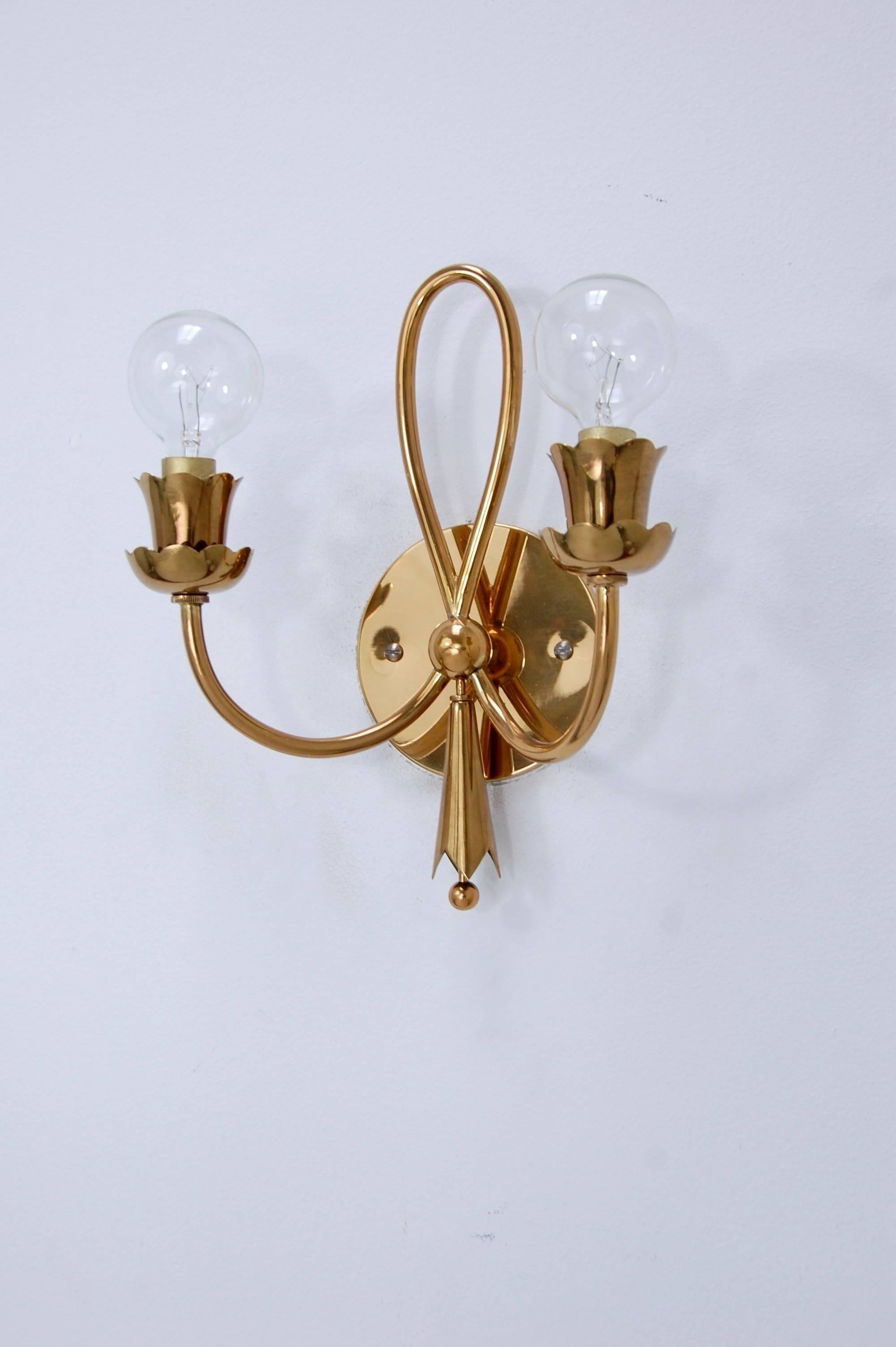 Iconic late 1940s Italian brass sconces in a botanical motif. Two candelabra based sockets per sconce. Fully restored, and rewired for use in the US. We can also rewire for any country upon request.
