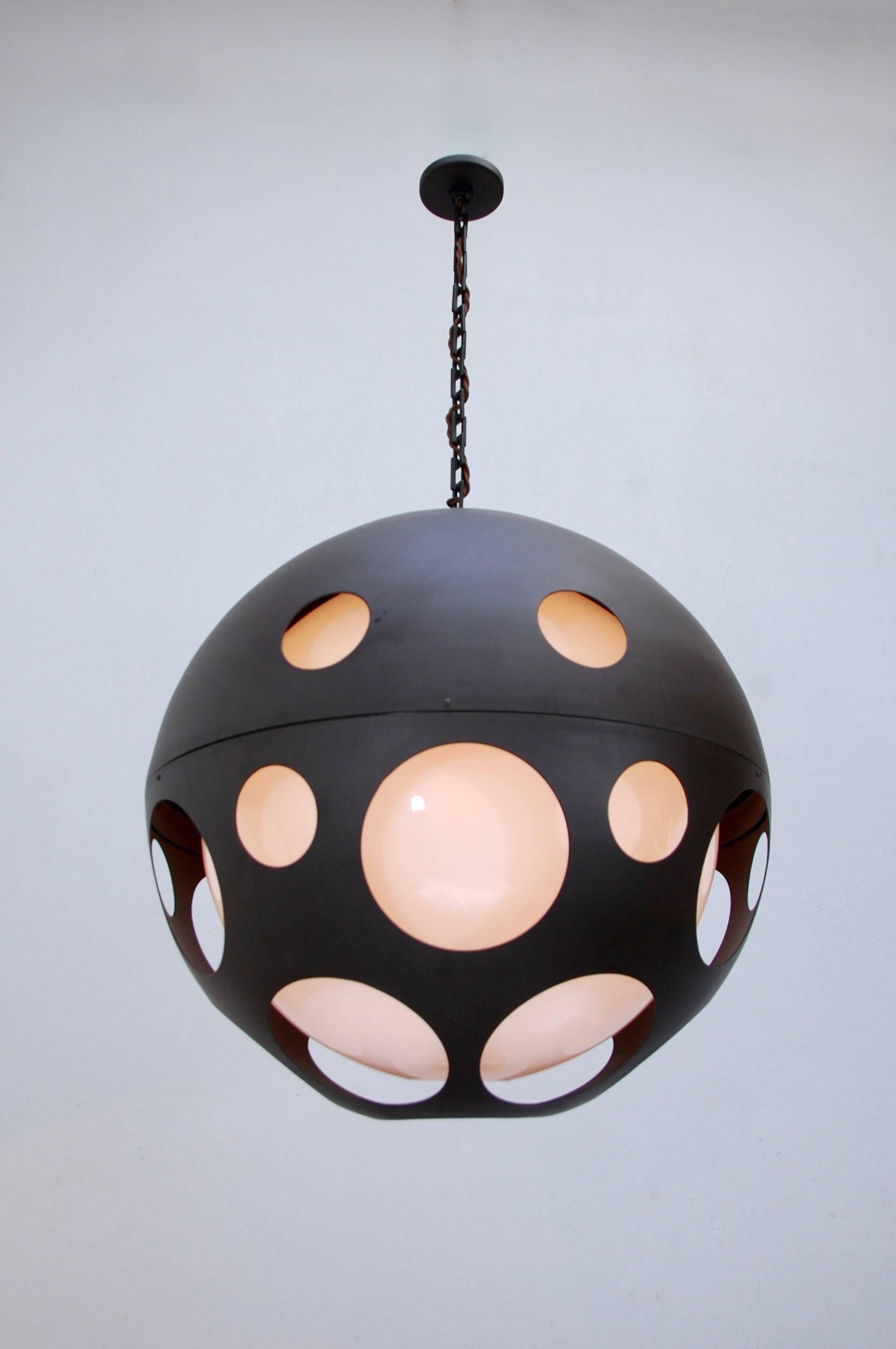 Large perforated globe pendant from circa early 2000s in powder coated aluminium and acrylic. Overall drop adjustable upon request.

Measures: Diameter 24”
Current overall drop 44”
Acrylic internal globe 18”.
 