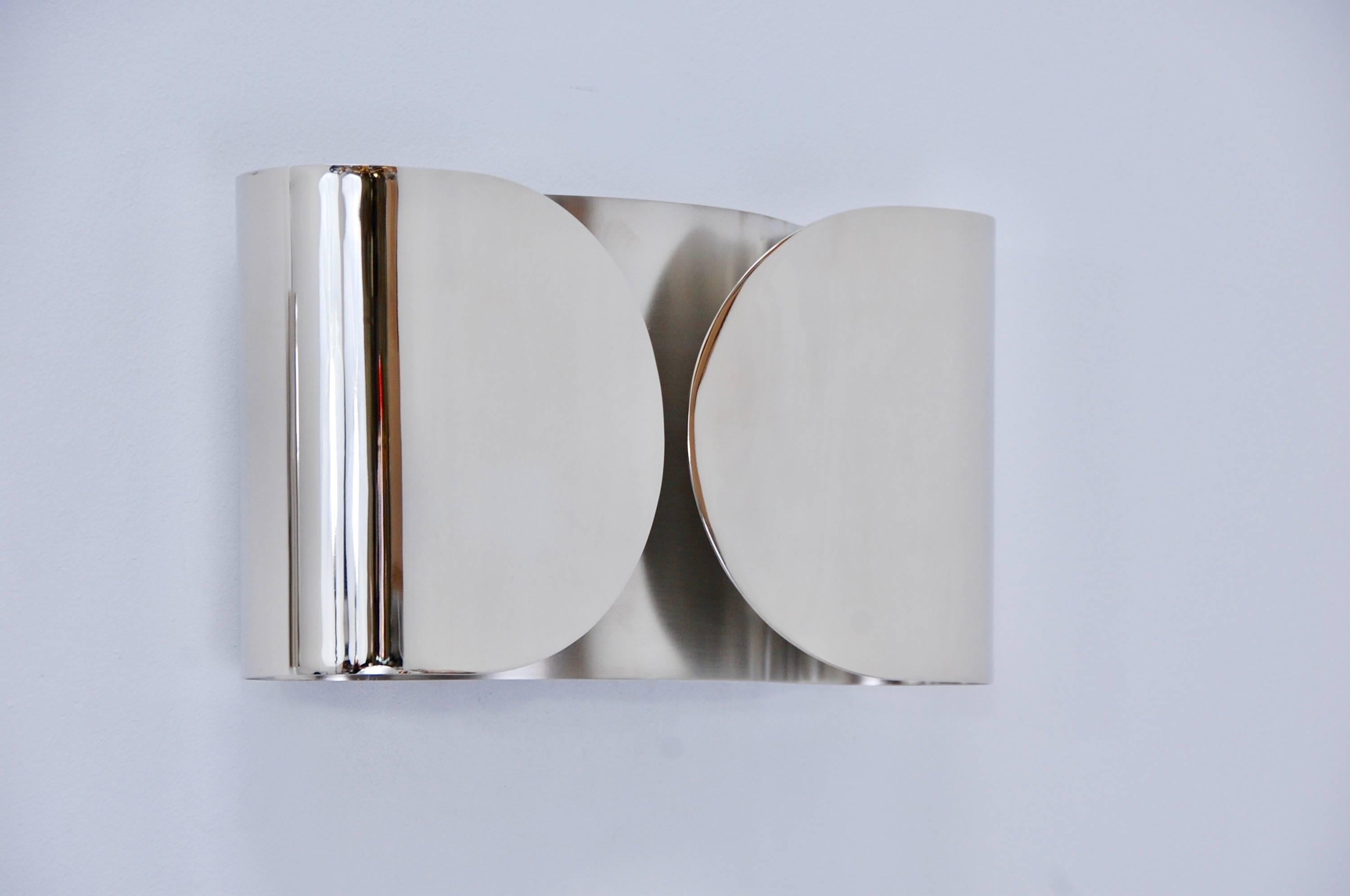 Phenomenal modern and sleek pair of Foglio sconces by Tobia Scarpa in satin nickel outside and lightly aged un-lacquered satin nickel finishes inside.