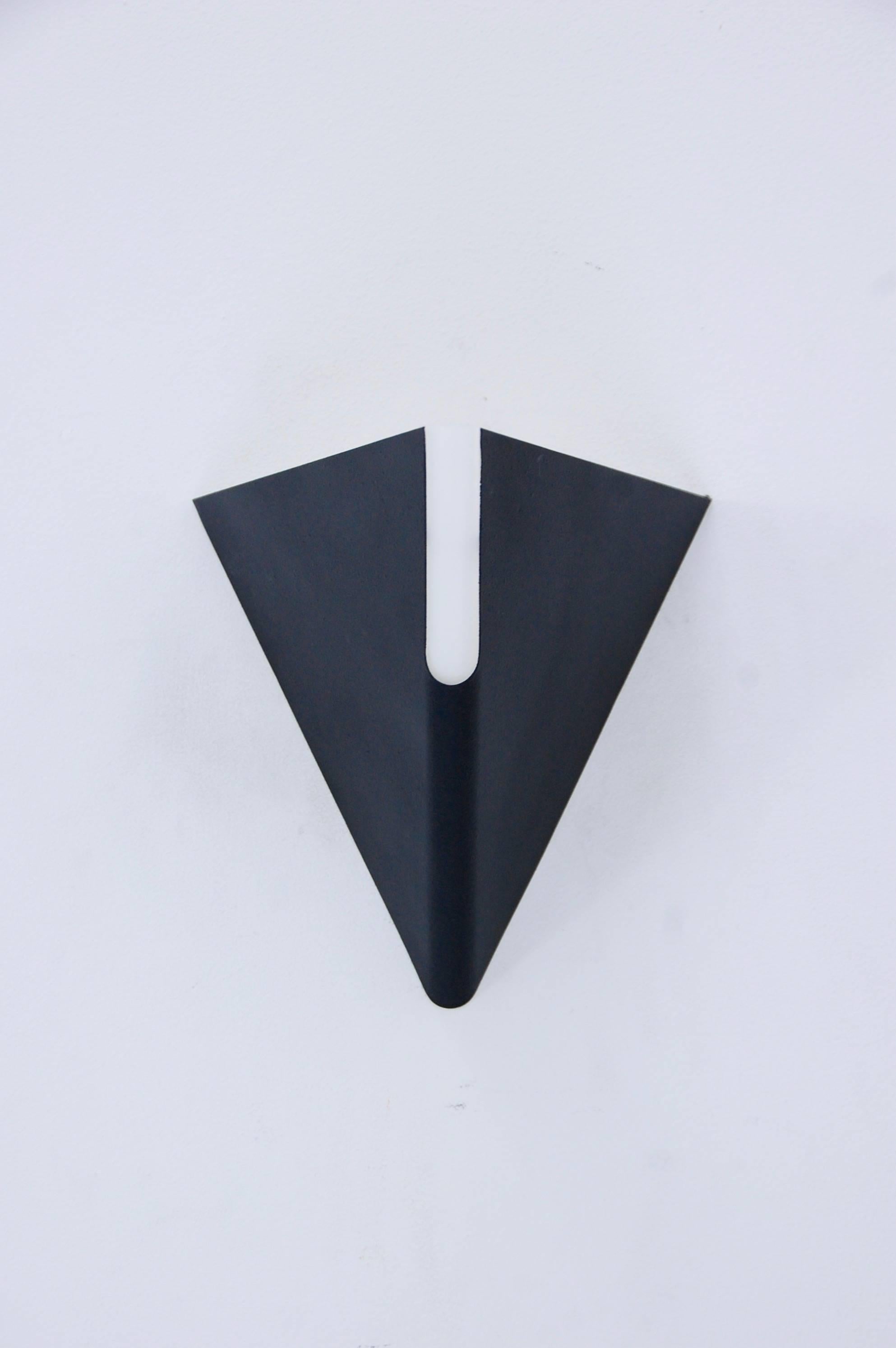 Four sharp and dynamic triangular sconces from the 1970s. Modern design with sleek lines. From Italy. Painted textured steel and glass. Rewired for use in the US. 
Measures: Depth 9.5”
Height 10"
Width 9.75”.
 