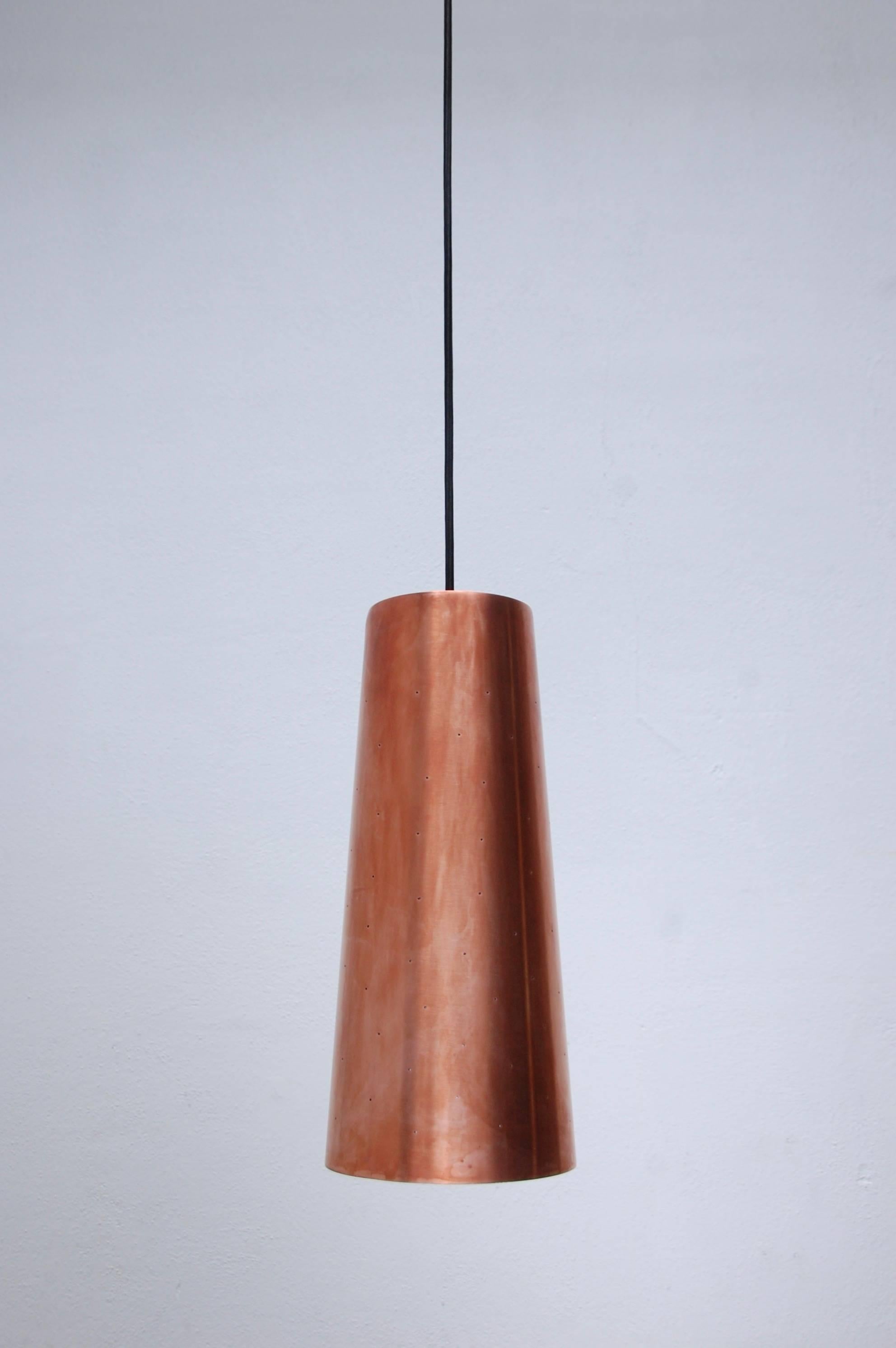 Fabulous large LUrco copper pendant with perforations. Made of solid copper. Interior is an off white painted finish and the exterior is un-lacquered patinated copper. Has a single medium based socket 100 watts maximum. OAD adjustable on site.