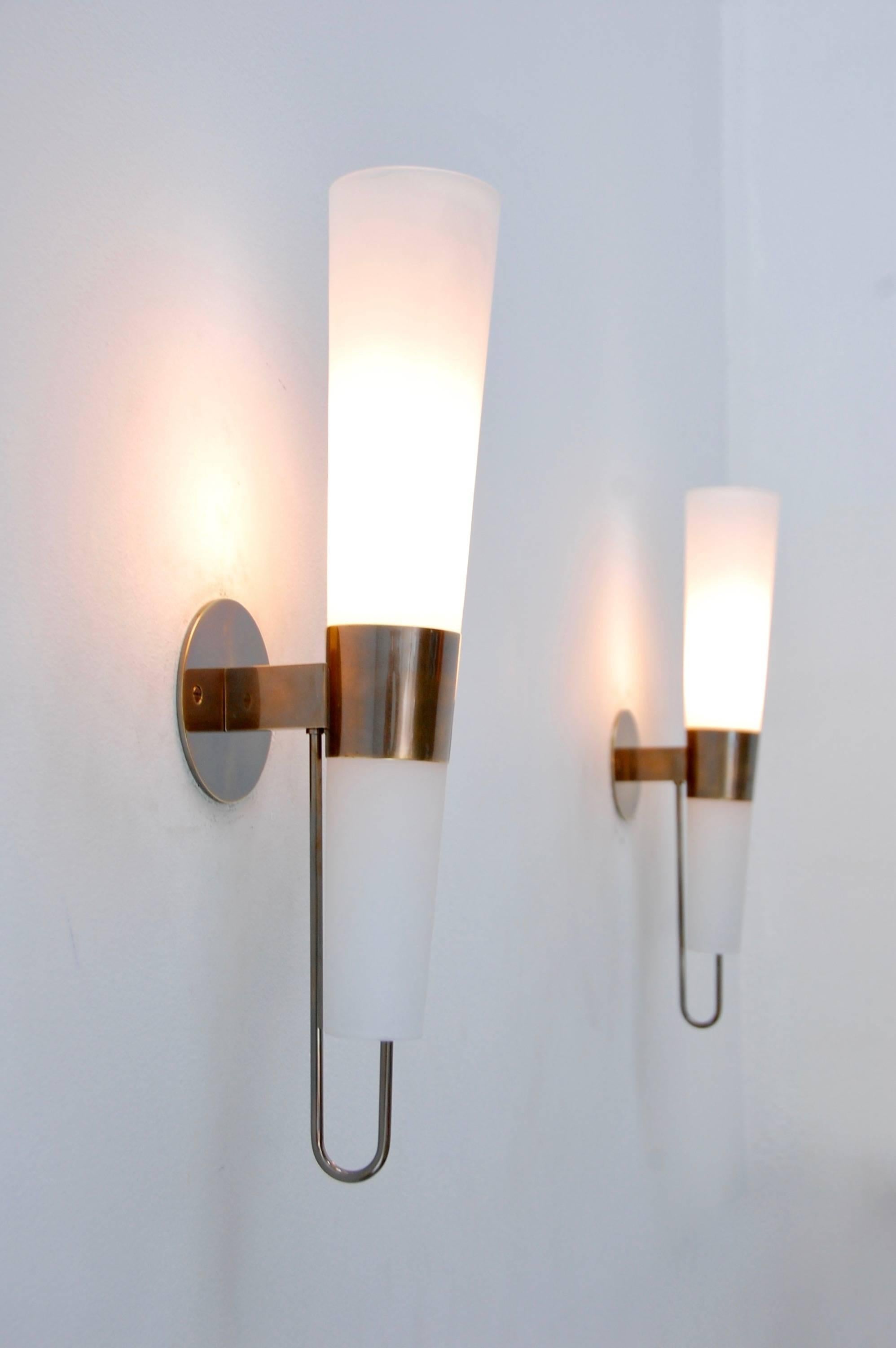 The LUchiere sconce is a wonderful and sleek bronze torchier sconce in a rich aged patinated brass finish and handblown glass shades. Based on an Italian design. Single medium based socket per sconce. Priced individually.
Measures: Height: