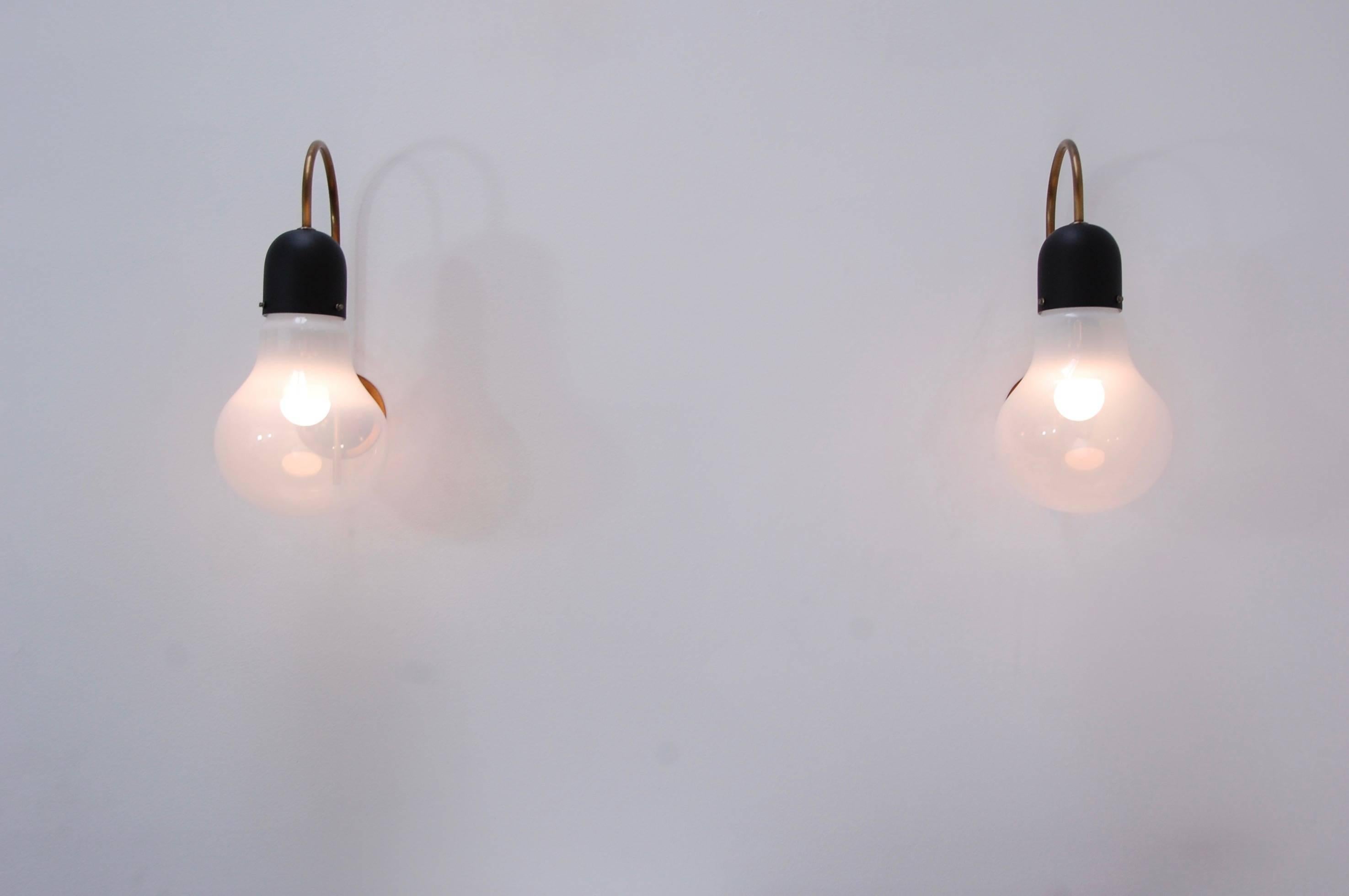 Pair of unique Mid-Century indoor or outdoor sconces from Stilux, Milano, Italy. Single E26 medium based socket. Wired for use in the US. Partially restored. Back plate 4” with 2 ¾” centre to centre mounting holes.

We at Lumfardo Luminaires do