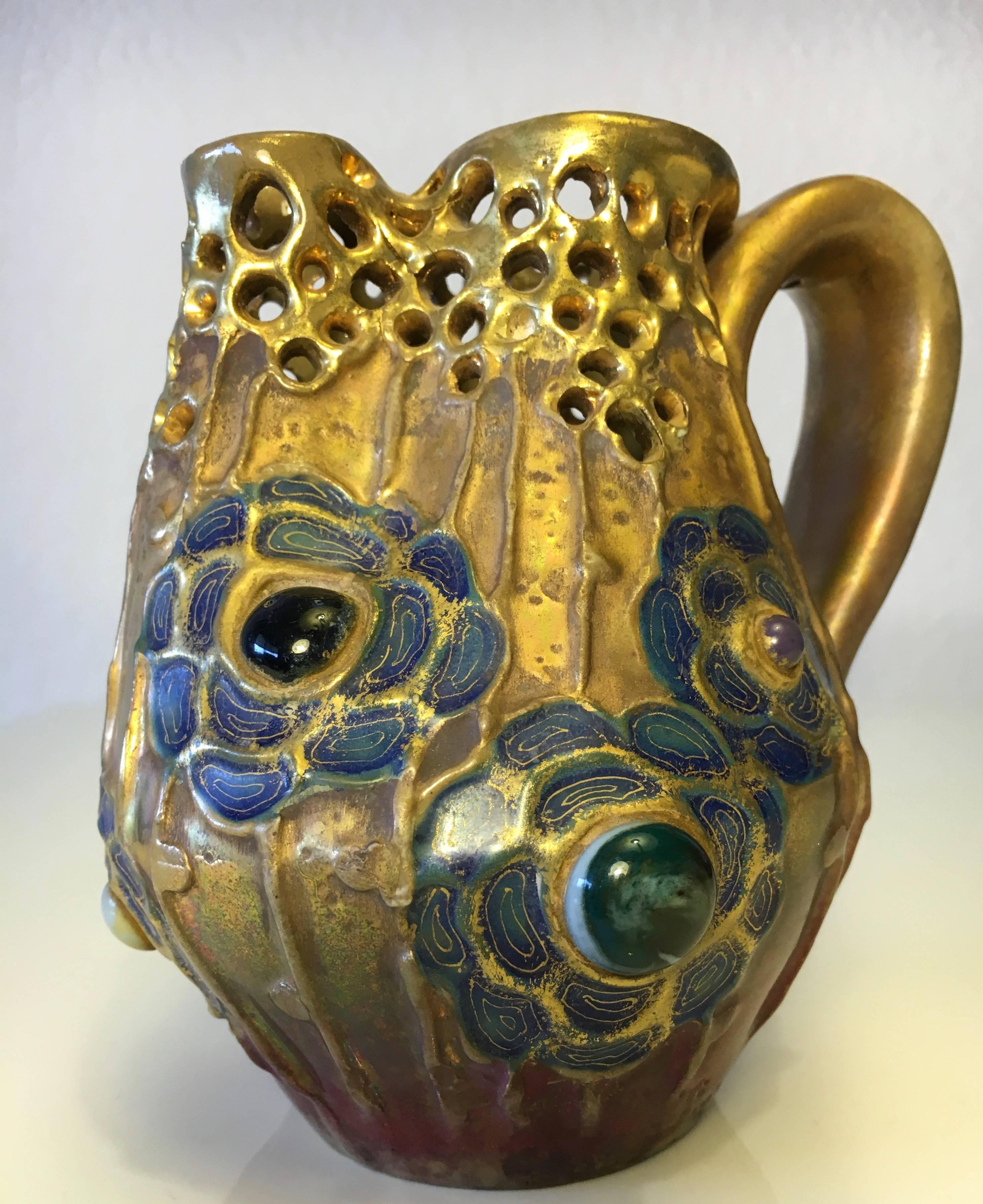 Riessner & Kessel small pitcher, better know as Amphora, a Bohemian ceramics producer, introduced its Gres-Bijou series in 1904, at a moment of consumer fatigue with Art Nouveau movement's focus on floral ornamentation.
This biomorphic series, with