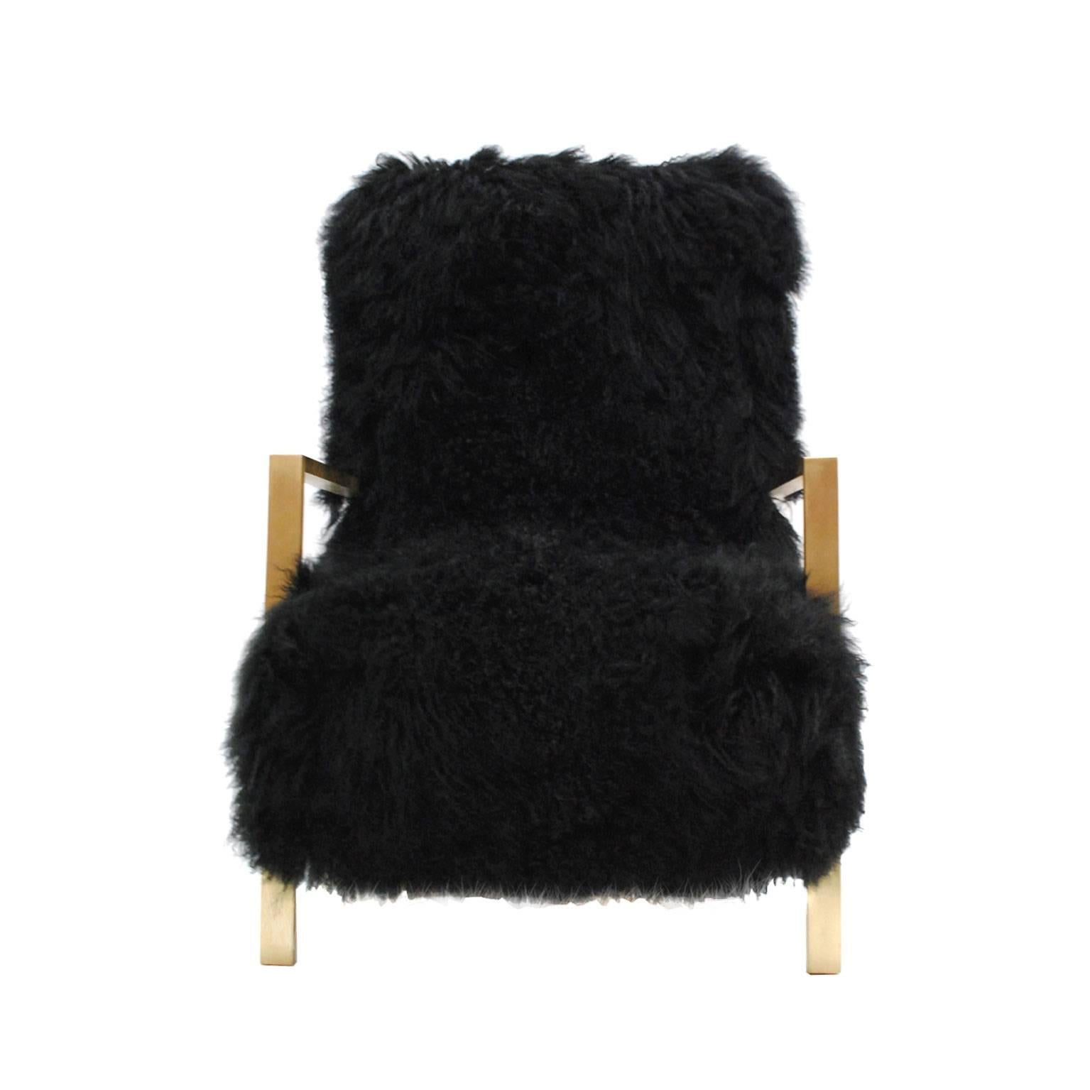 Pair of armchairs with structure made in solid wood, metal and brass upholstered in natural Mongolian goat fur.