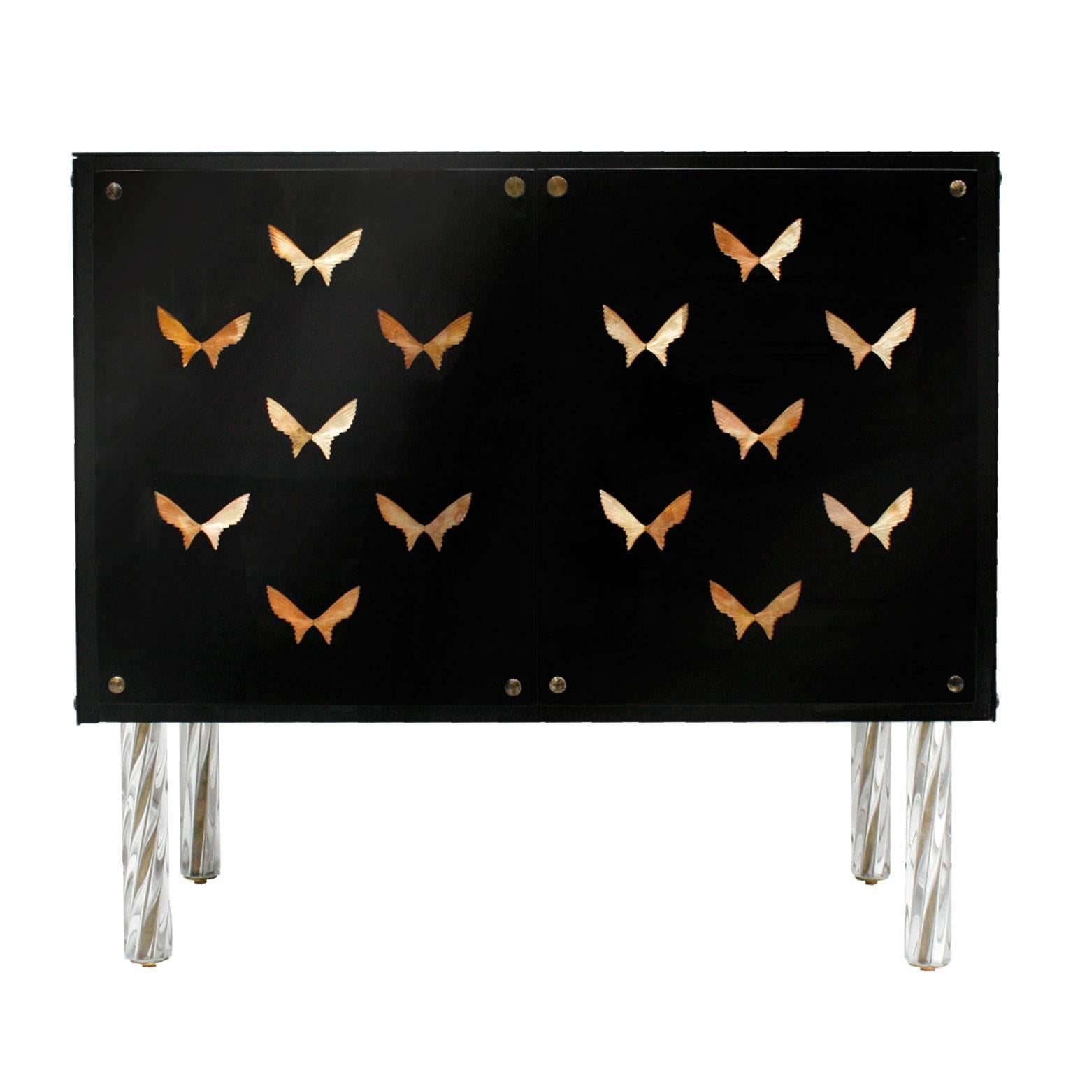 Pair of commodes, with wood structure covered in black Lacobel glass and decorated with bronze butterflies.
Legs made in turning glass.