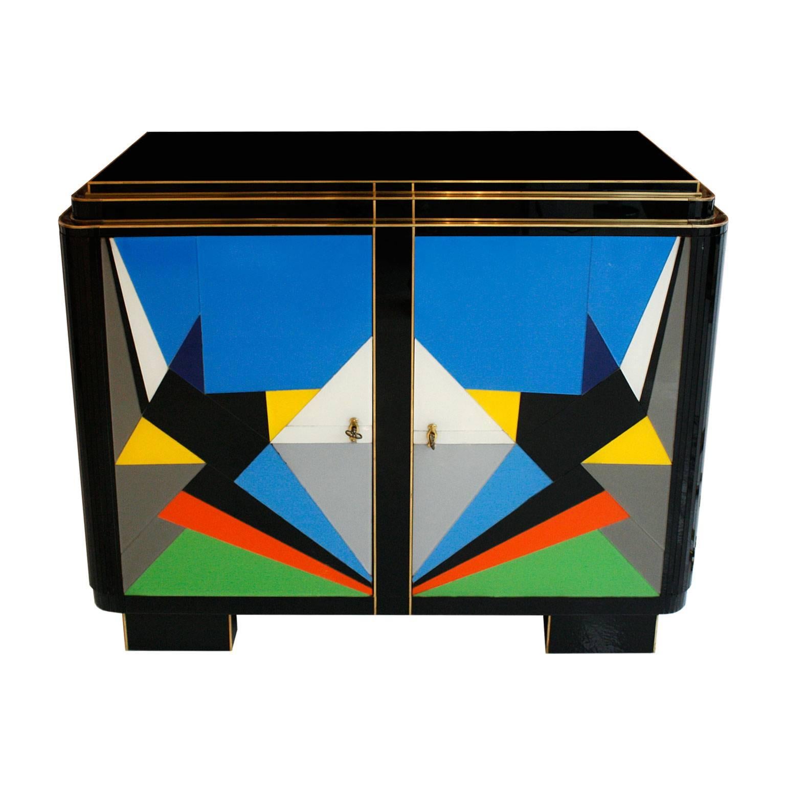Sideboard composed by two doors. Made in solid wood structure and finished in Murano glass with brass profiles.