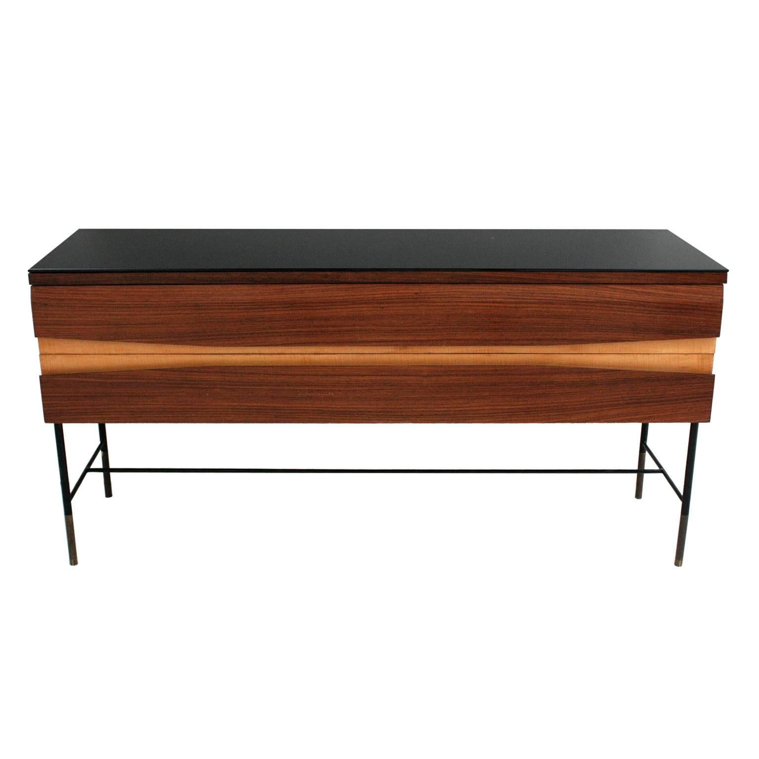 Sideboard made in solid wood covered in rosewood and birch. Legs with metalic structure with brass sheath. Black lacquered crystal on top.
 