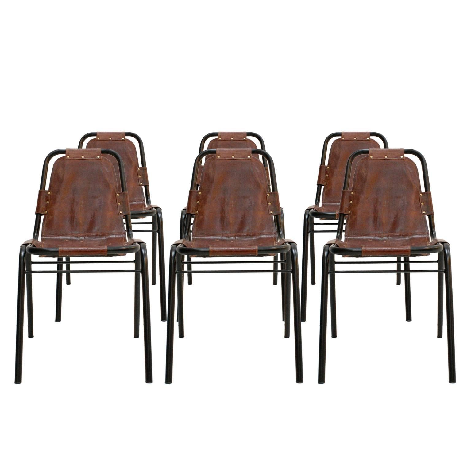Set of ten chairs mod. "Les Arcs", with tubular structure in black, lacquered steel with seat made of leather, in the style of Charlotte Perriand, France, 1970s.