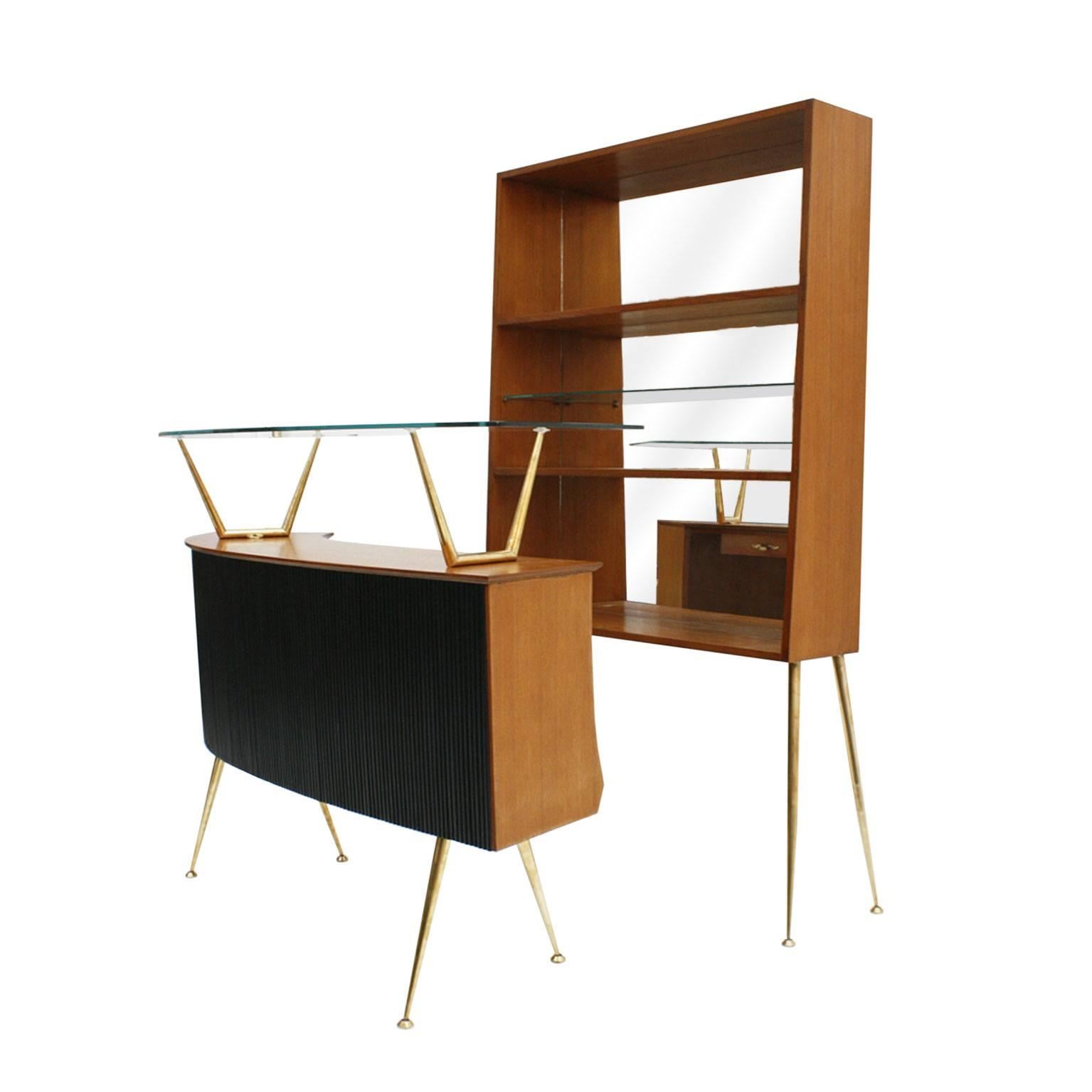 Dry bar composed by bar and shelve made up of solid wood. Solid wood structure with front panelling, feet and details made of brass. Shelf made of wooden shelves and transparent glass and interior covered in mirror glass. Bar with compartmentalized