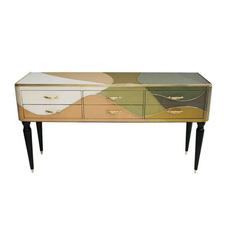 Sideboard composed of six drawers, with solid wood structure covered in Murano glass and brass details, Italy.