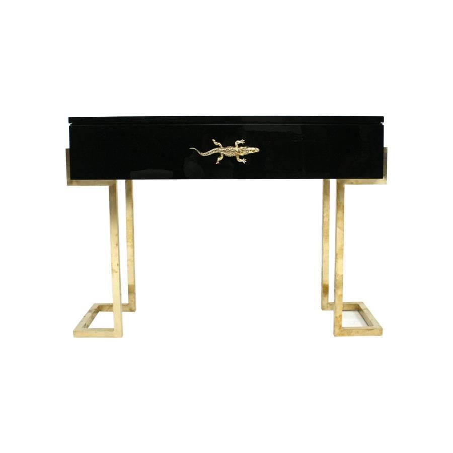 Pair of consoles with wood structure lacquered in black, with crocodile handles made in chiseled bronze, hand-hammered, and brass legs.