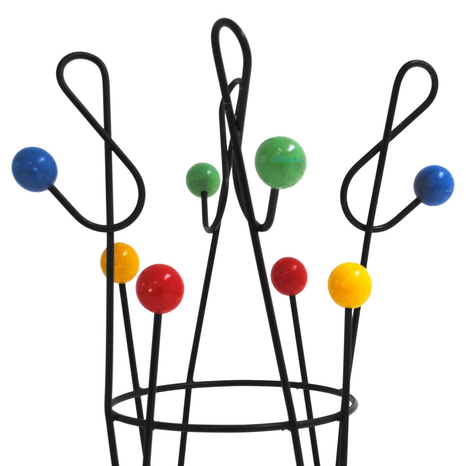 Mid-Century Modern coat rack designed by Roger Feraud. Composed of eight arms made of black lacquered iron structure, finishes in wood spheres in different colors. France, 1950s.



 