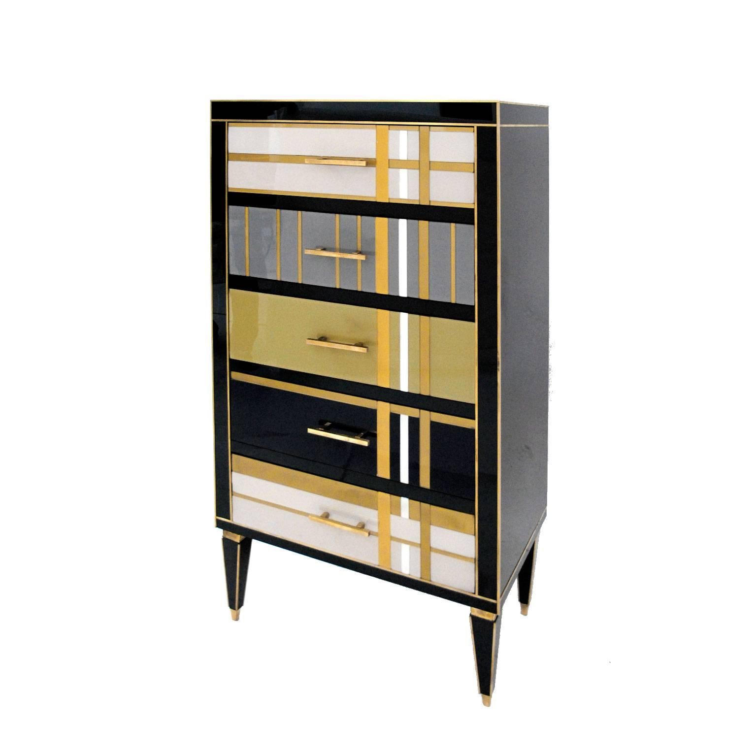 Commode composed by five drawers, made ins olid wood covered in different colors Murano glass, finished in brass.