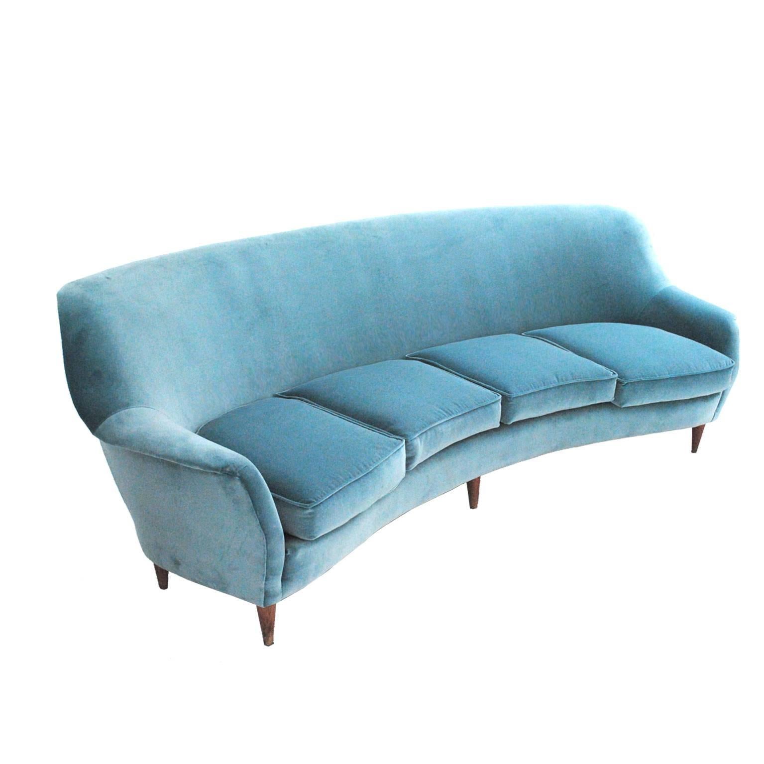 Italian curved four-seated sofa with structure made in solid wood upholstered in light blue cotton velvet edited by Gancedo with foot in solid oak.