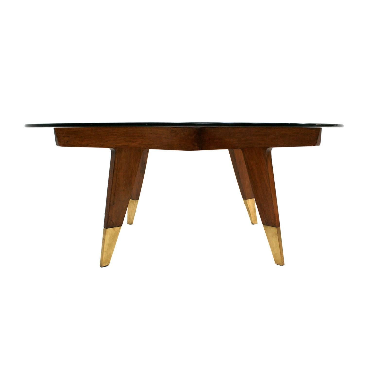 Original Compass cocktail table by Gio Ponti for singer and sons made in walnut, terminating with brass sabots.