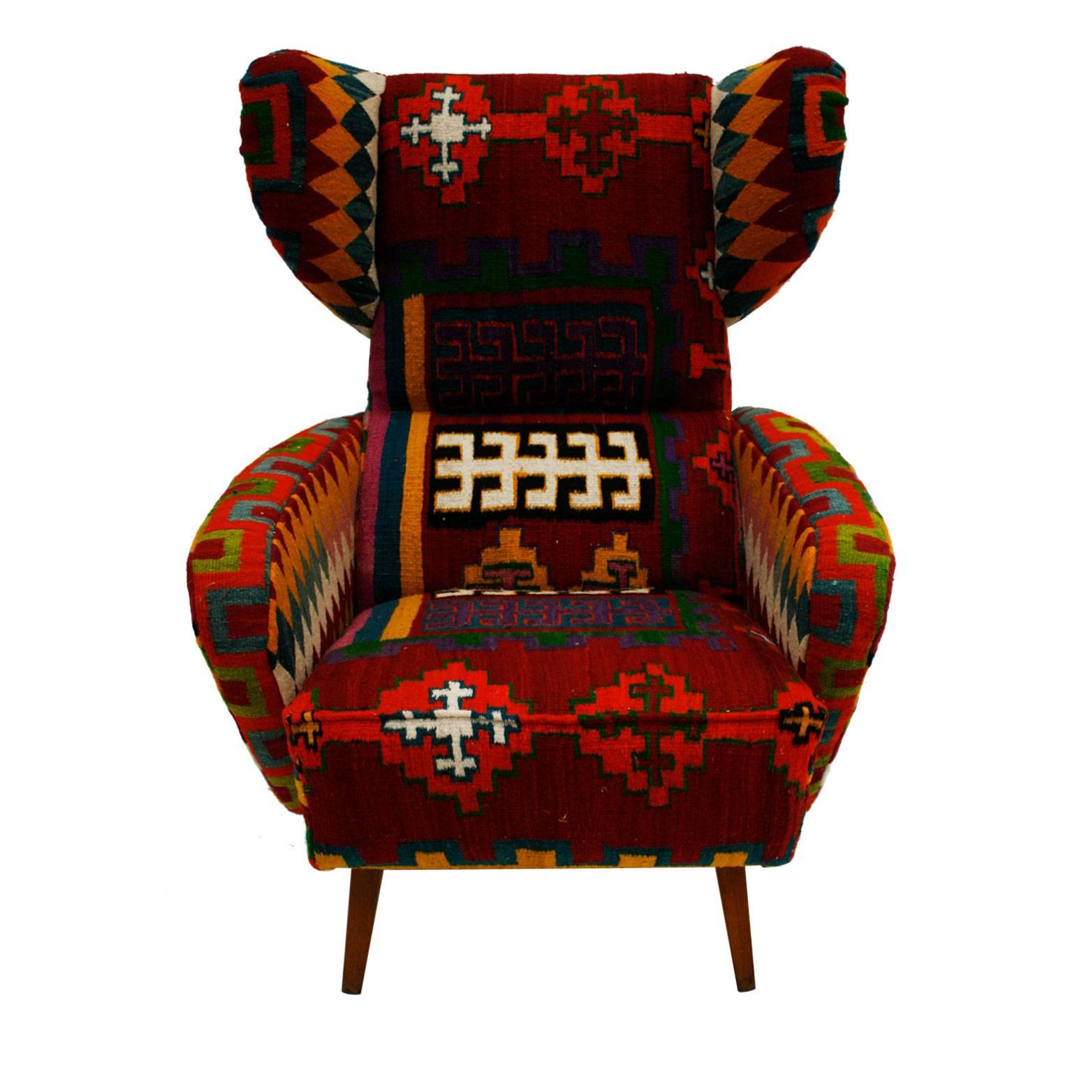 Wingback armchair made in real wood. Upholstered in Midcentury fabric from the area of the Balkans.