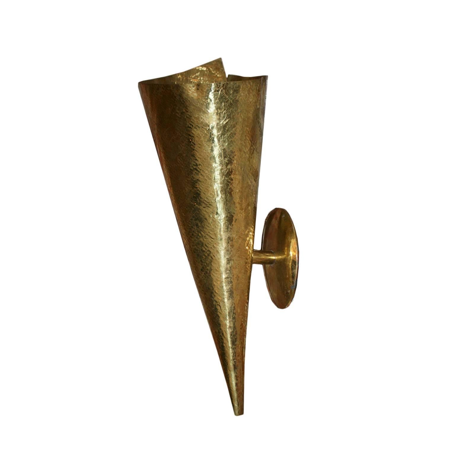 Pair of sconces made in brass with conic form and finished with hammered technique.