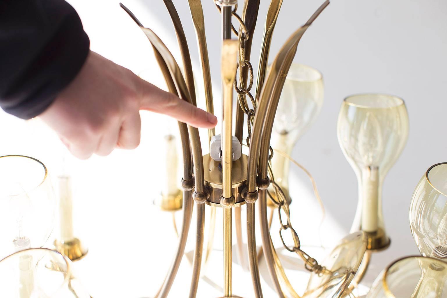 Designer: Unknown.

Manufacturer: Lightcraft of California.
Period or model: Mid-Century Modern.
Specs: Brass, tinted glass.

Condition: 

This brass chandelier is in good vintage condition. The brass has patinaed differently throughout the