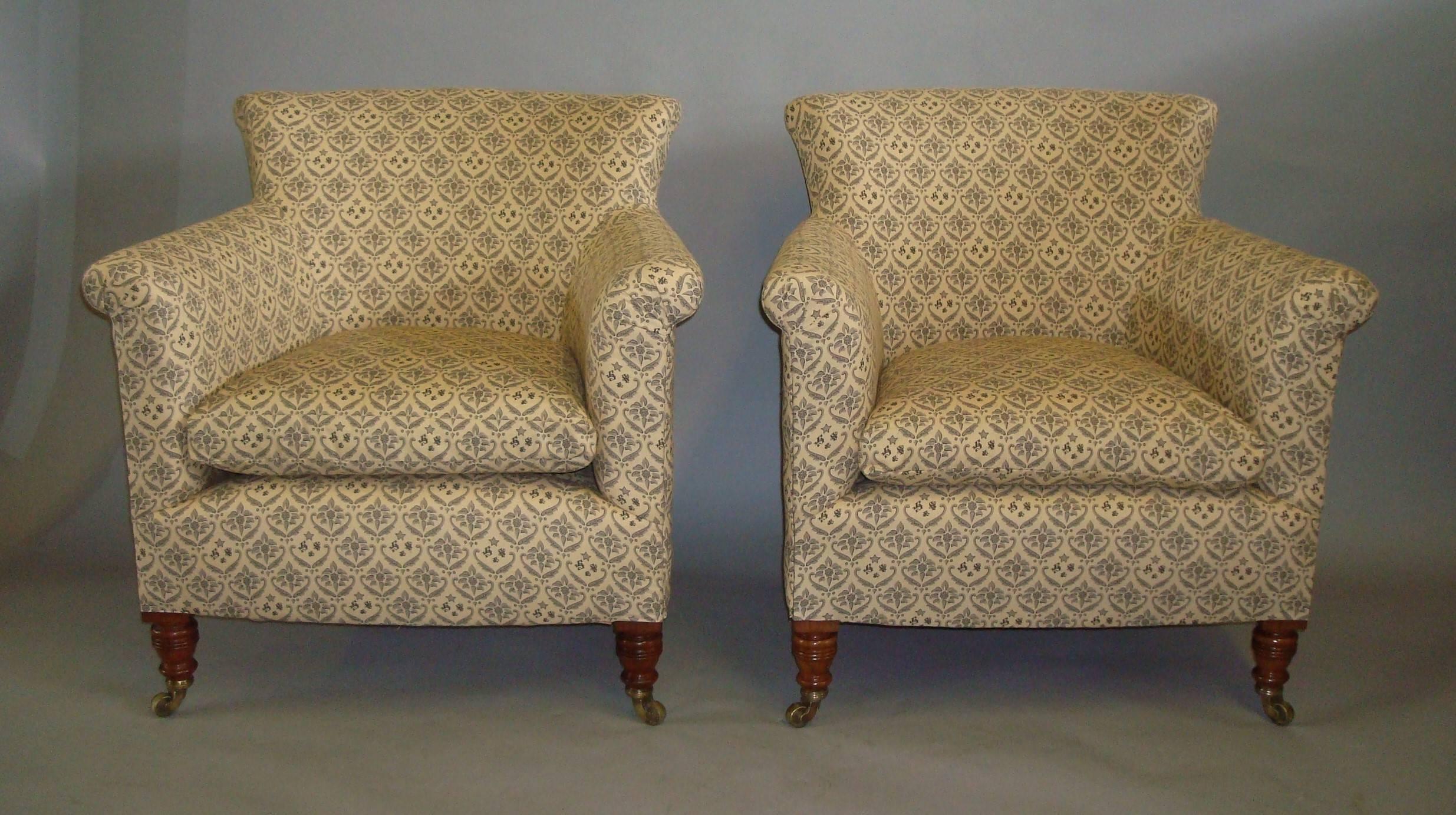 Late 19th century pair of Howard and Sons walnut tub shaped armchairs, of neat proportions. Newly reupholstered in grey and cream monogrammed Howard and Sons style printed cotton. The curved padded backs and rollover straight arms with a feather