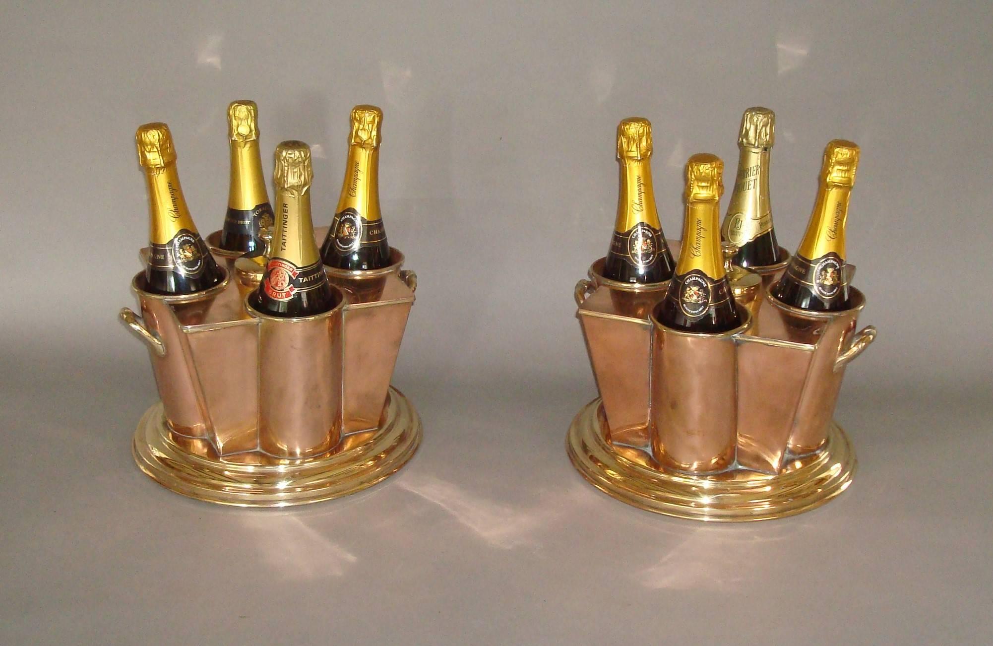 An exceptional early 20th century pair of  champagne/wine coolers, these rare ocean liner champagne/ wine coolers in copper and brass, of stylish Art Deco form. Stamped 