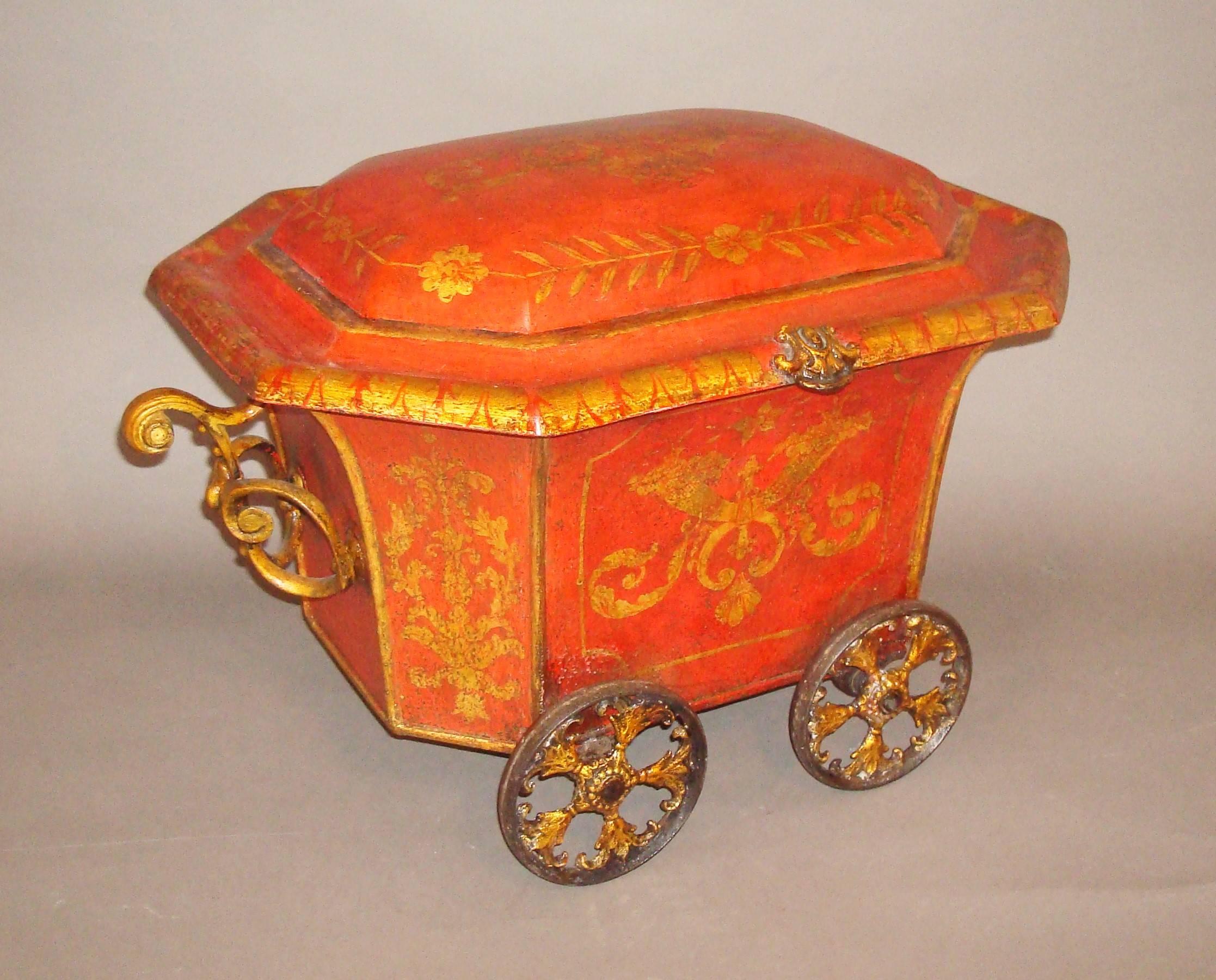 Good Regency painted tole coal box or coal hod; with gilded classical scrolled and foliate decoration on a scarlet red background; of sarcophogus form, the domed lid with shaped surround and a small gilded iron handle to the front. The main body
