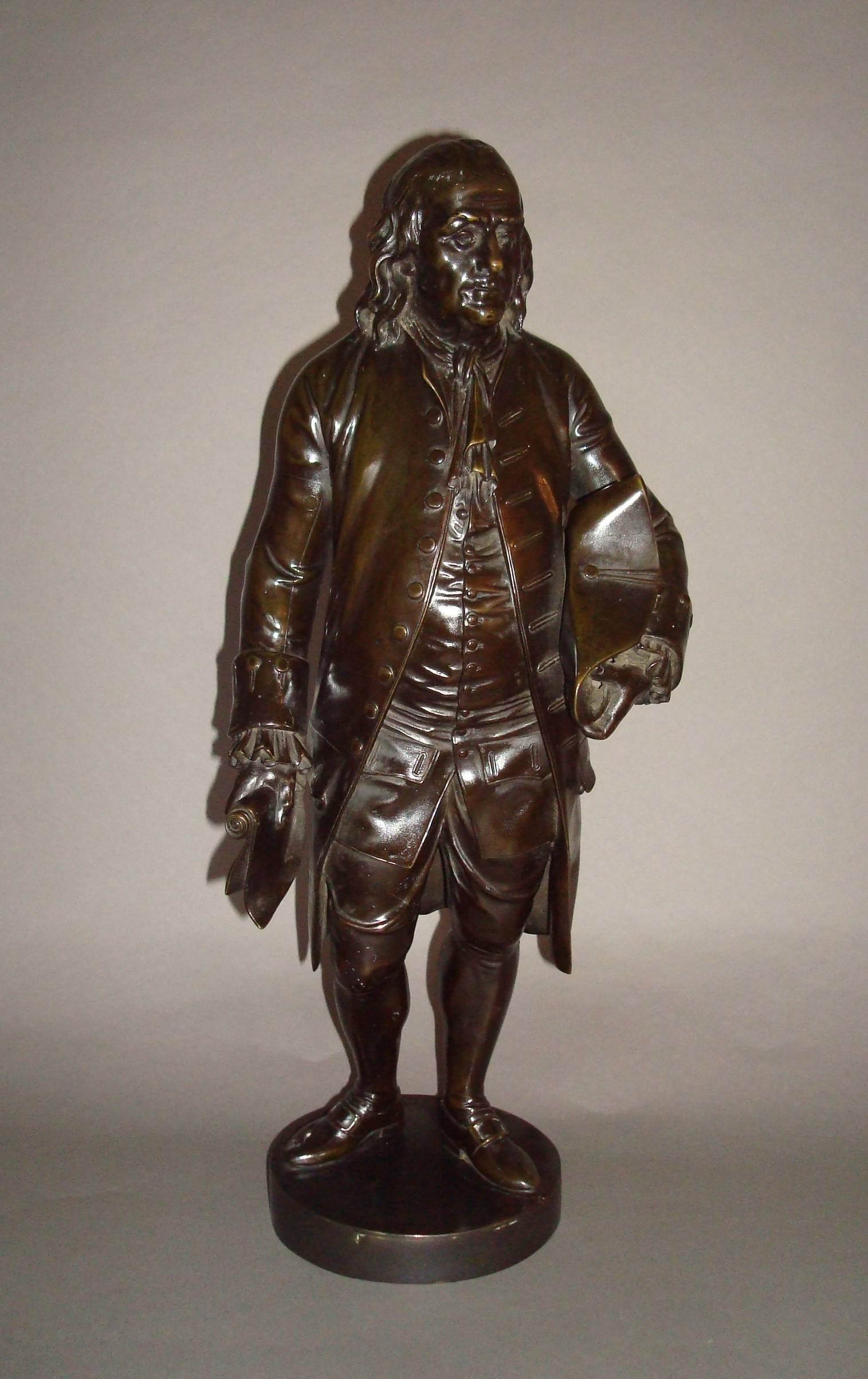 A rare 19th century bronze statue of Benjamin Franklin; stood in all of his finery holding a paper scroll in his right hand and his tricorn hat under his left arm, raised on a circular plinth.  A good quality casting with a rich brown