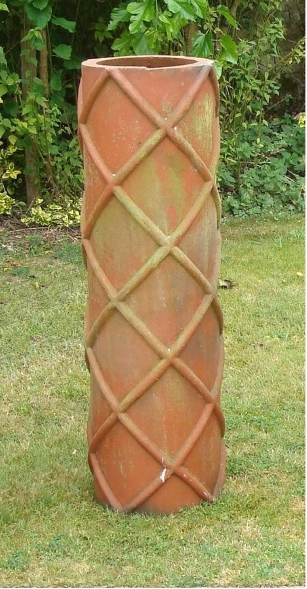 An unusual large trio of 19th century terracotta chimney pots of cylindrical form with contrasting decoration consisting of a lattice design, a morroccan design and a spiral design. With a good architectural look, would be great in a garden as