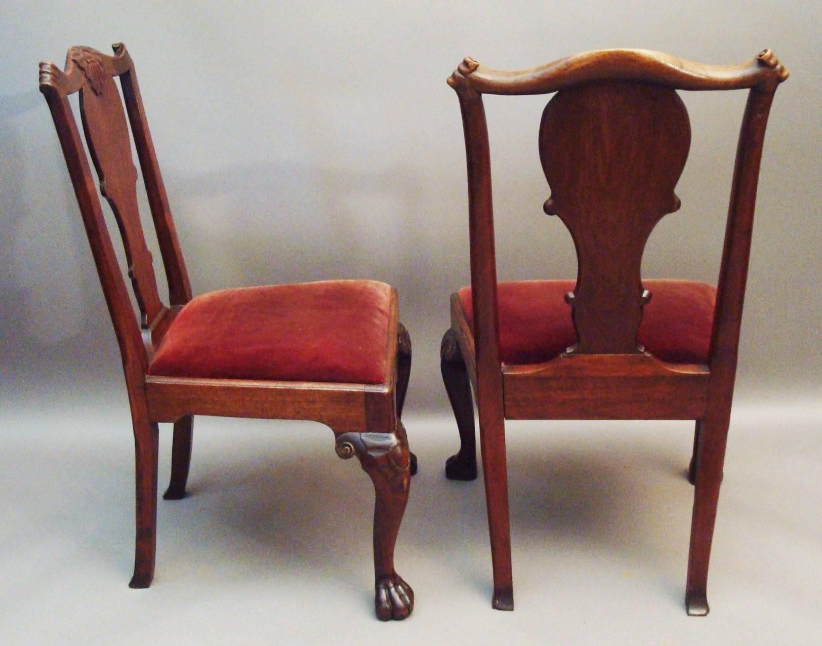 George II pair of Irish walnut side chairs, the shaped top rail with a central carved cresting and terminating in paper scroll ends above a wide, shaped solid splat; and a drop in seat housed in a shaped frame with a moulded edge; standing on