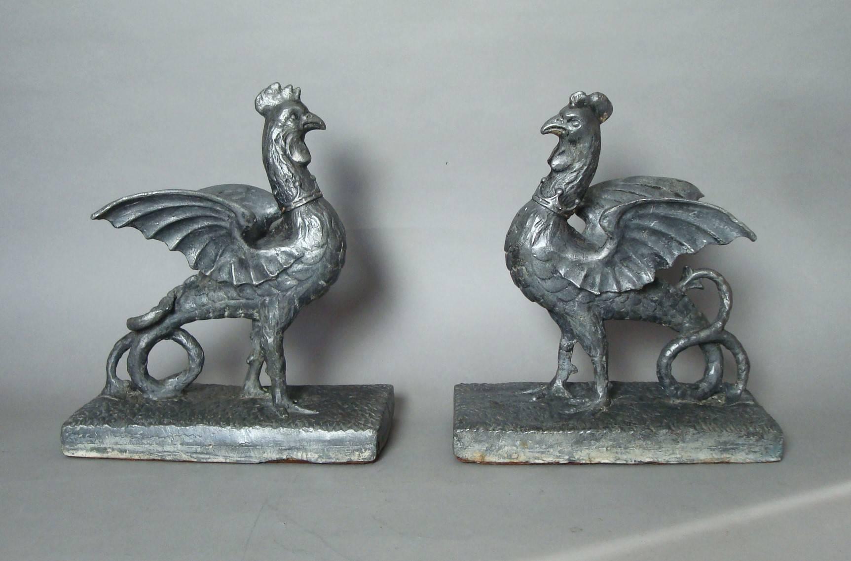 Rare 18th century pair of lead Cockertrice "Heraldic Cockerels", poised in an alert stance, and very unusually wearing a coronet around their necks, presumably made for a royal or titled family standing on a naturalistic plinth base, with
