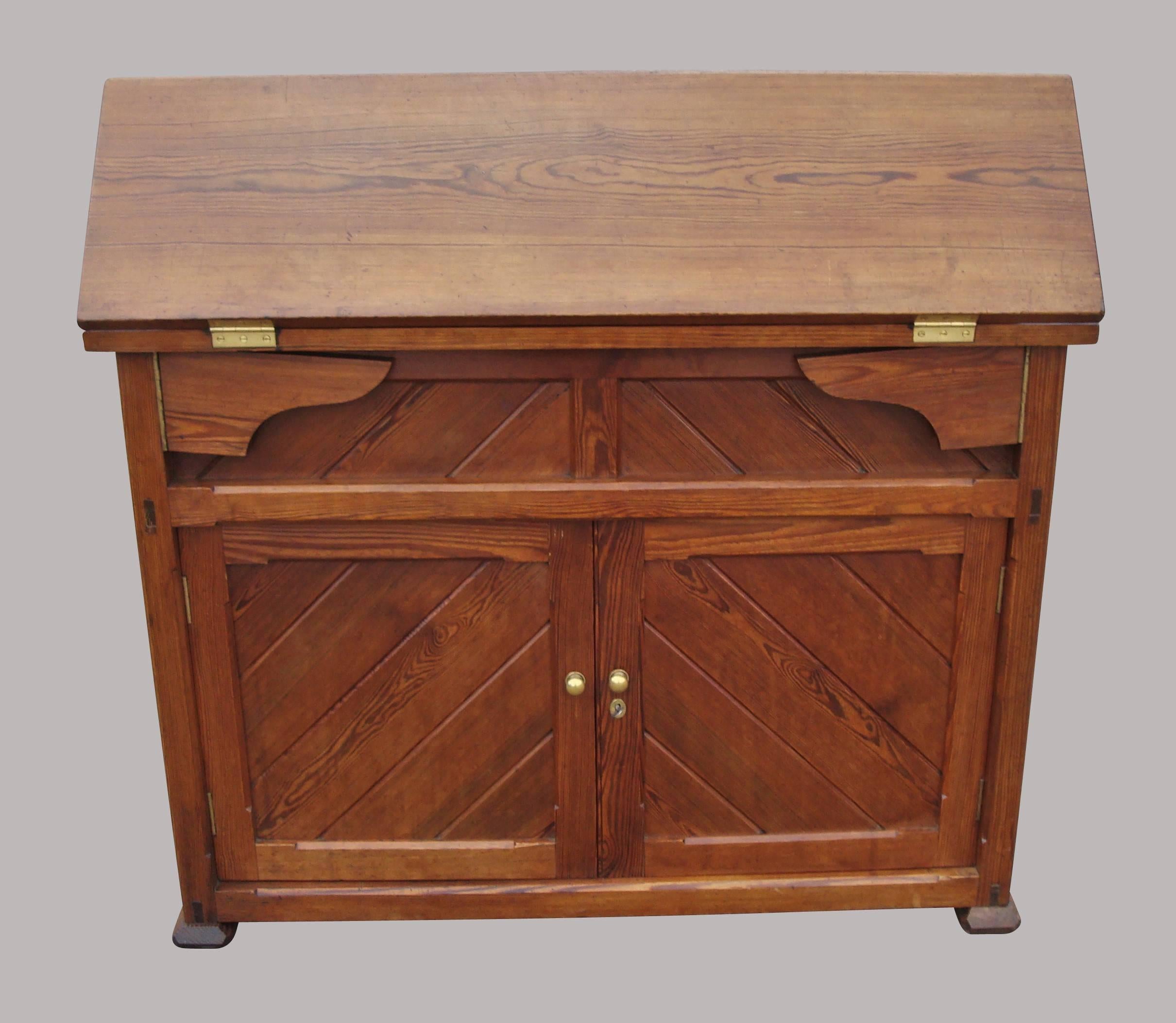 A rare late 19th century pitch pine saddle horse or saddle rack; the hinged gabled top opening to make a large flat surface, supported on a pair of folding shaped supports to either side. The main body, which is panelled to all sides and of tapering