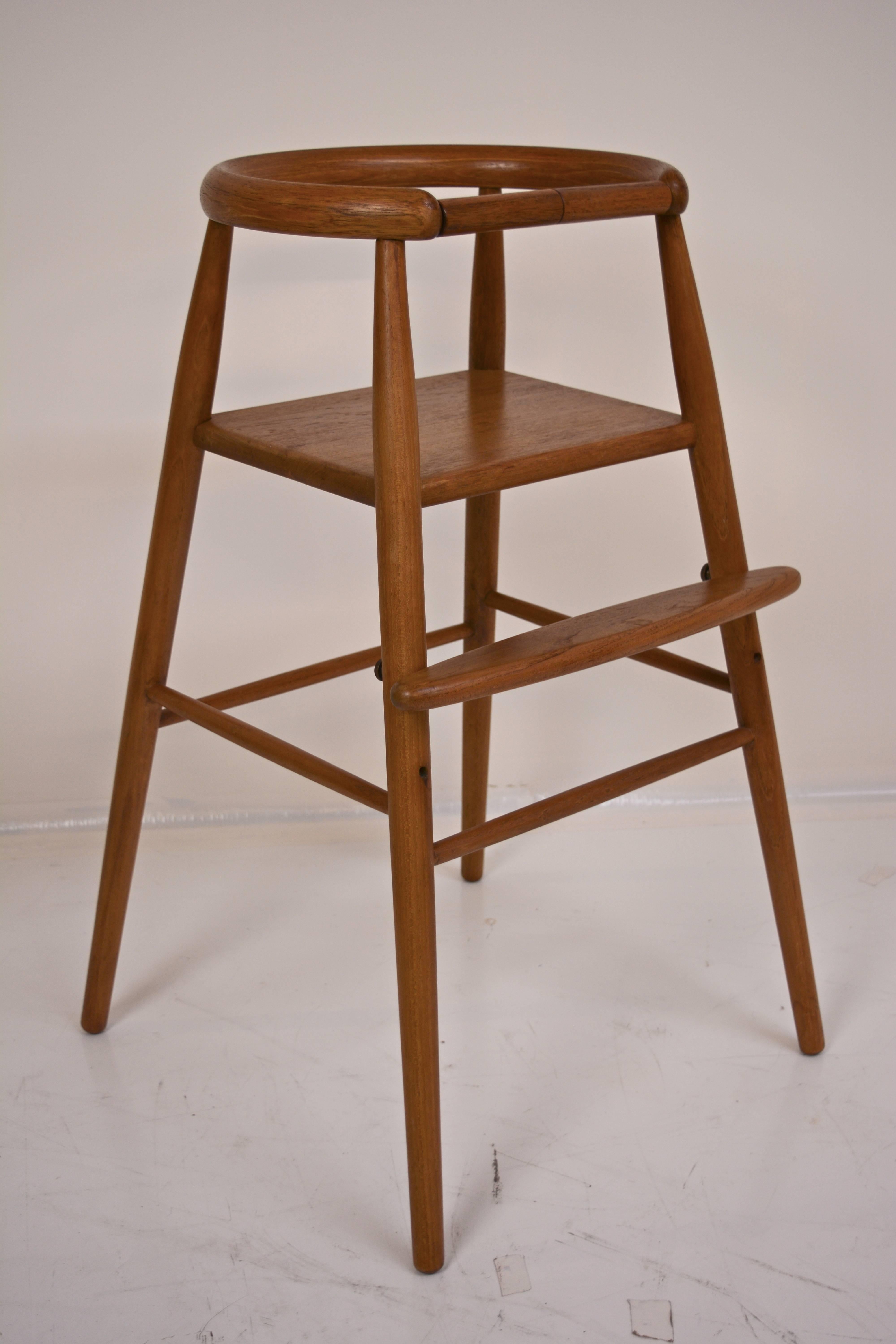 Solid teak child's high chair by Nanna Ditzel. Adjustable footrest. Excellent lacquer finished wood, circa 1950s.
  