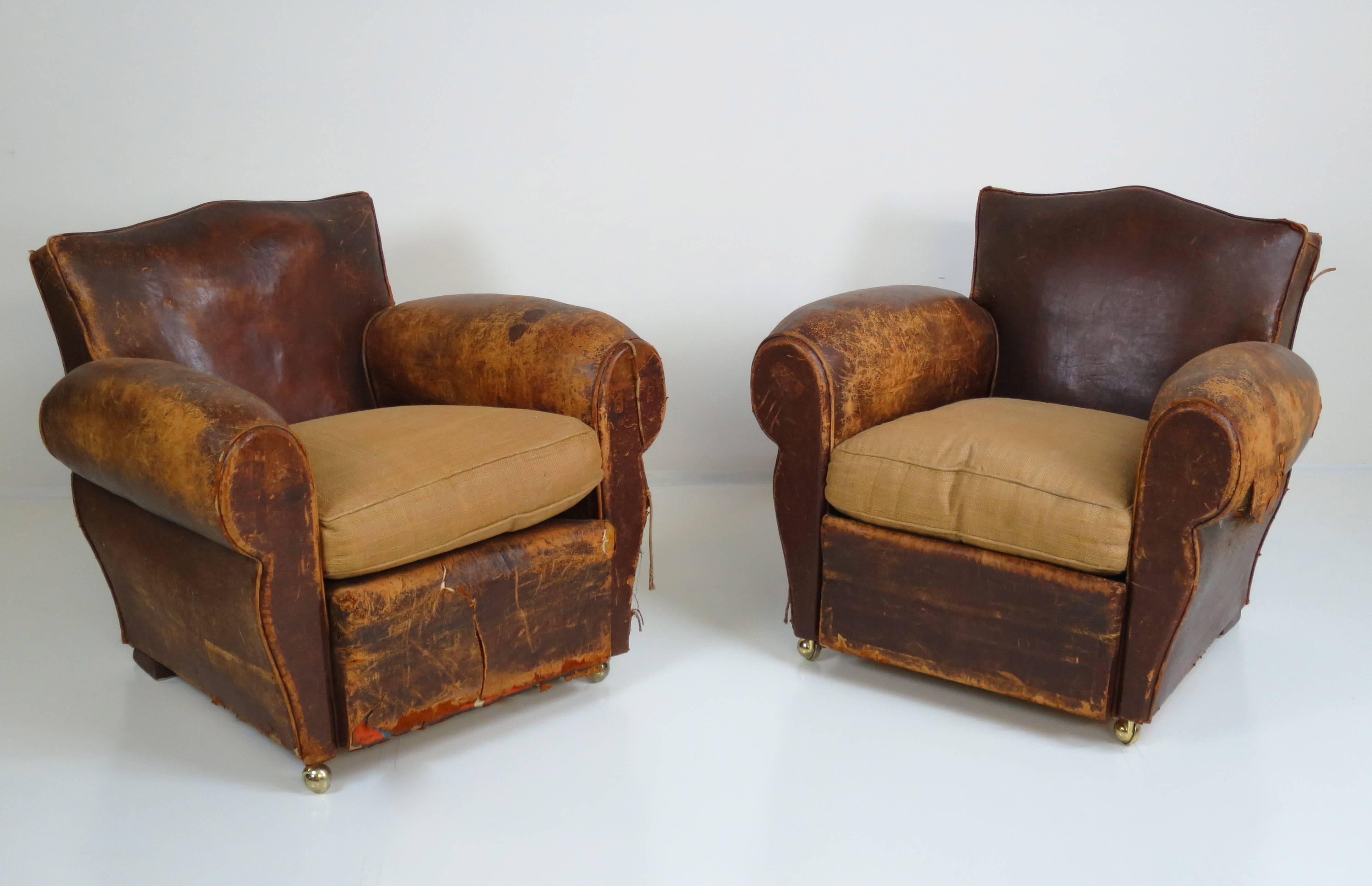Pair of French Art Deco club chairs. Distressed leather with original patina.
