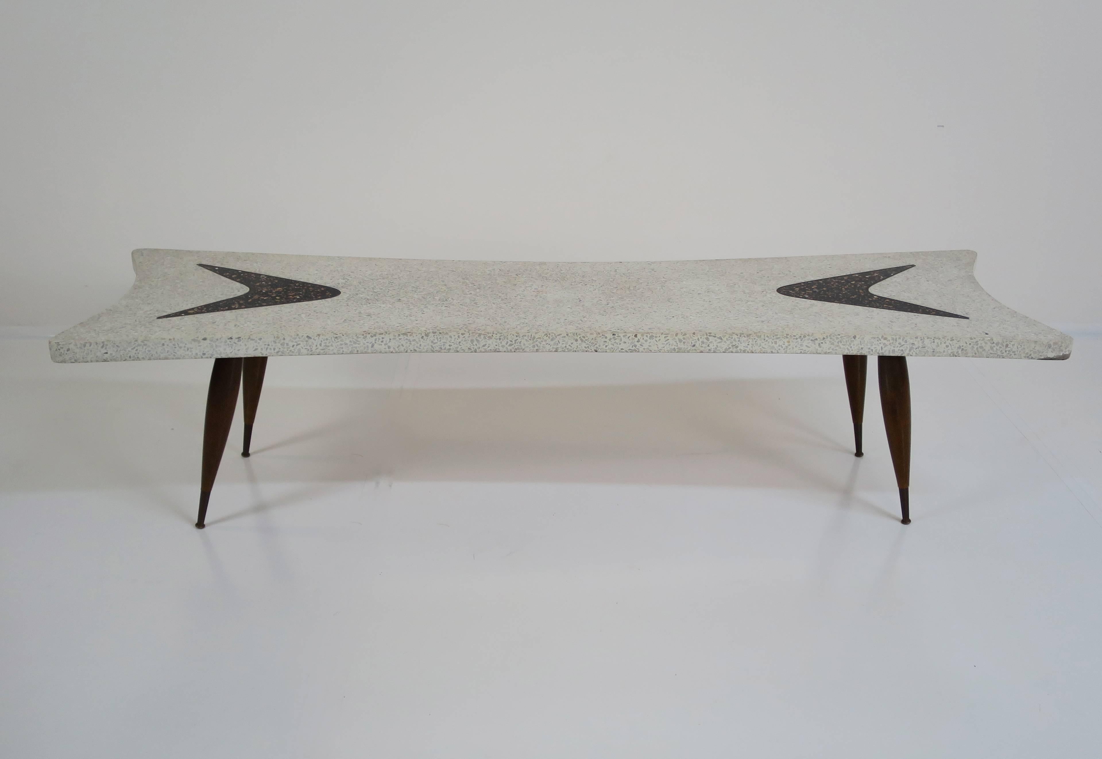 1950s Italian terrazzo coffee or cocktail table. Terrazzo top with tapered wood legs and solid brass sabots. Brass sabots display original patina but can be polished at no charge if you wish.