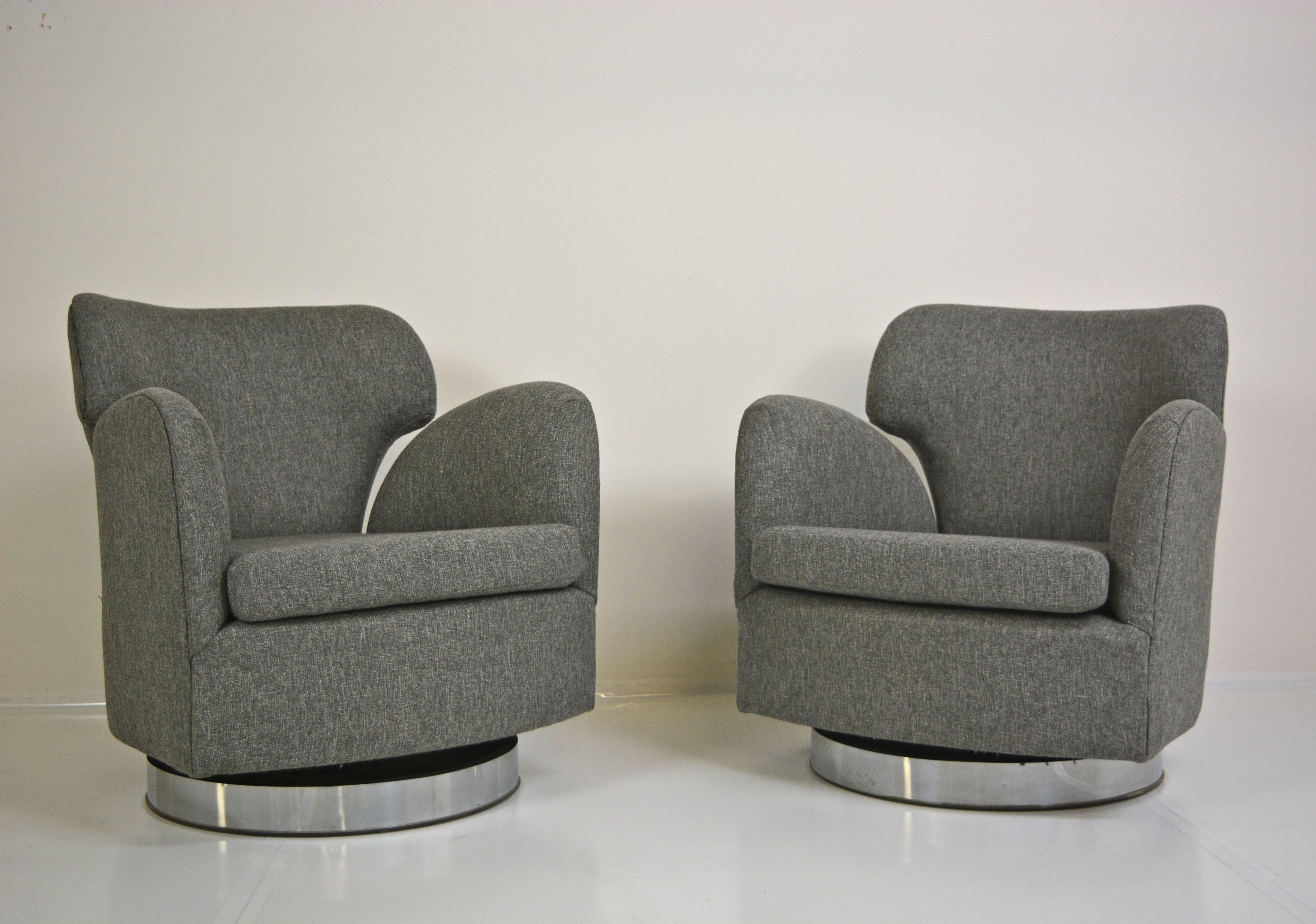 Pair of swivel chairs with reclining backs. Newly upholstered in lightly textured gray fabric. Designed by Milo Baughman, circa 1960s. 
(One additional matching pair also available).