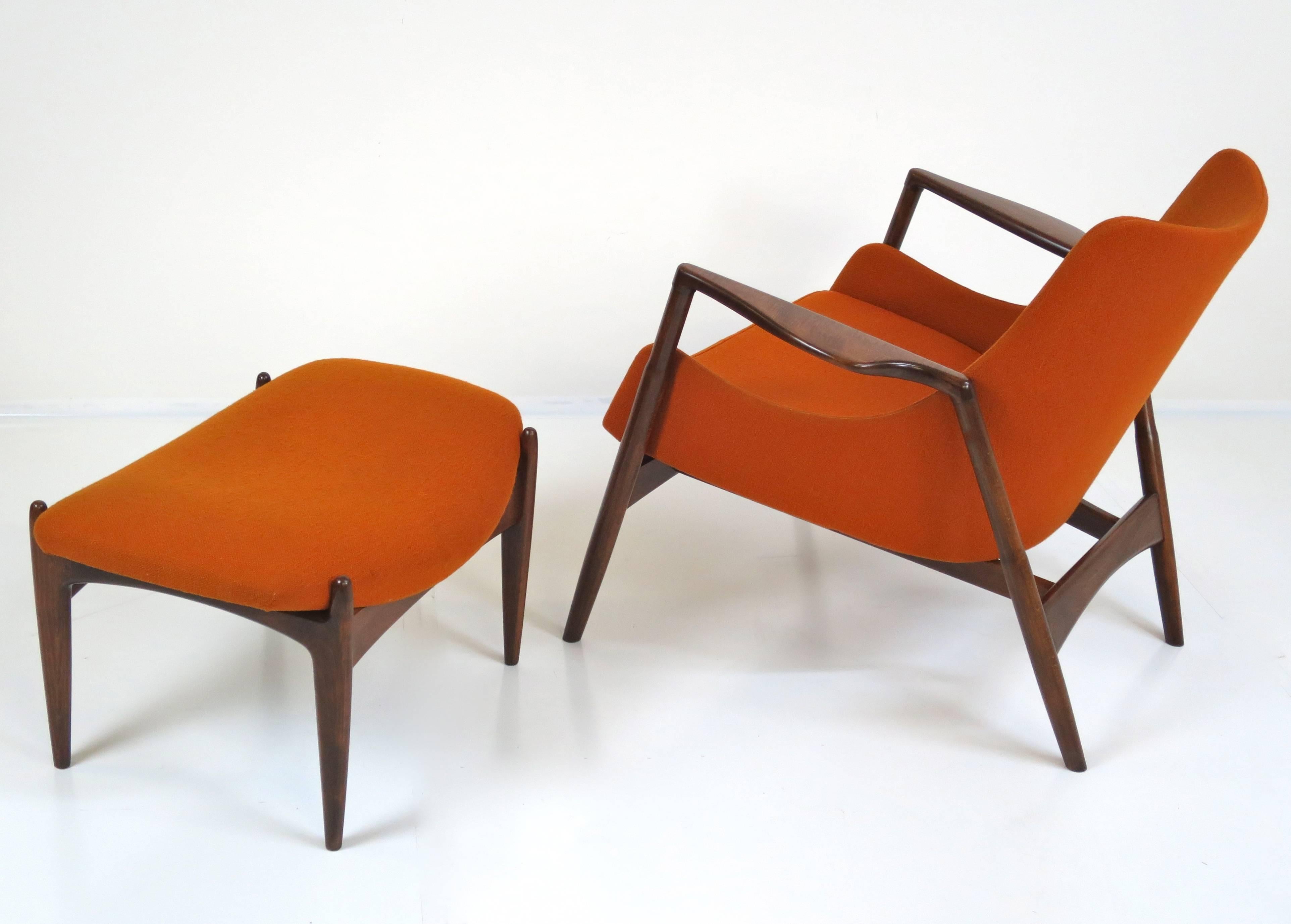 Rare Ib Kofod-Larsen lounge chair and ottoman. Solid wood frame has been refinished. The bright orange fabric is original. Imported by Selig.
Measures: Chair 32