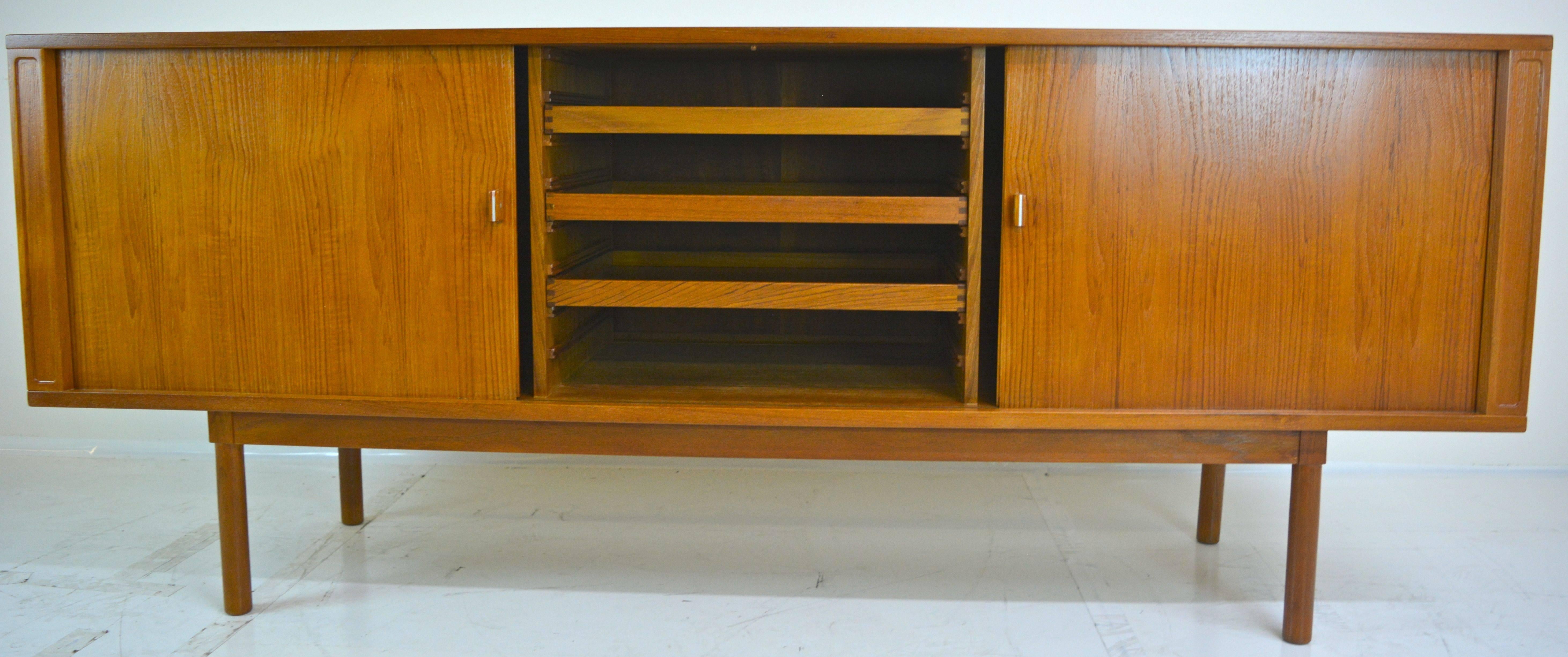Tambour credenza in teak by Jens Herald Quistgaard for Lovig in restored condition. Excellent stainless detail to door hardware, as shown.