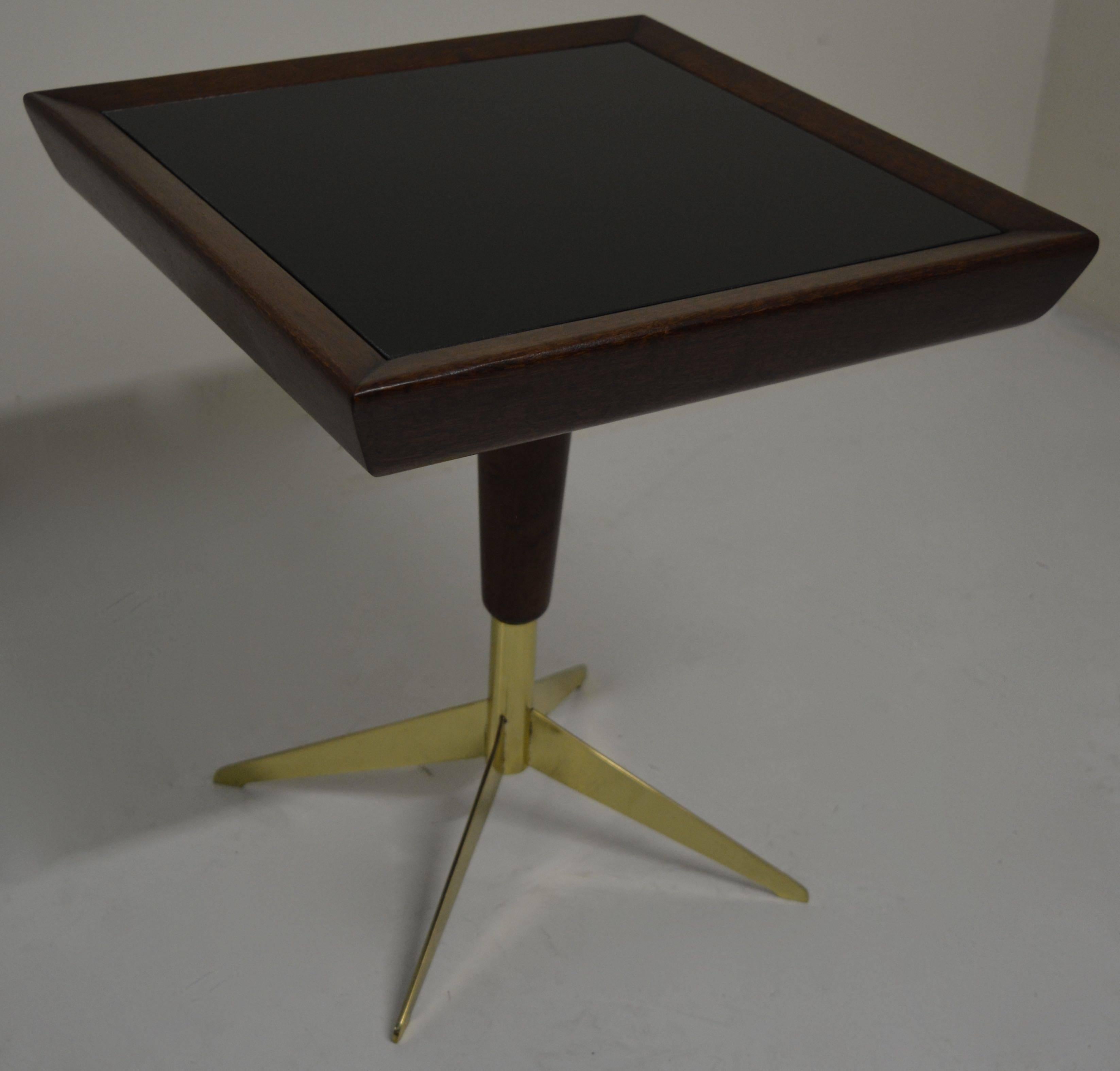 Petite Italian occasional table in walnut with polished brass base and black glass top, circa 1950s. This table has been restored and is ready for another 60 years of service. Perfect for the small area between a pair of chairs where a full-size