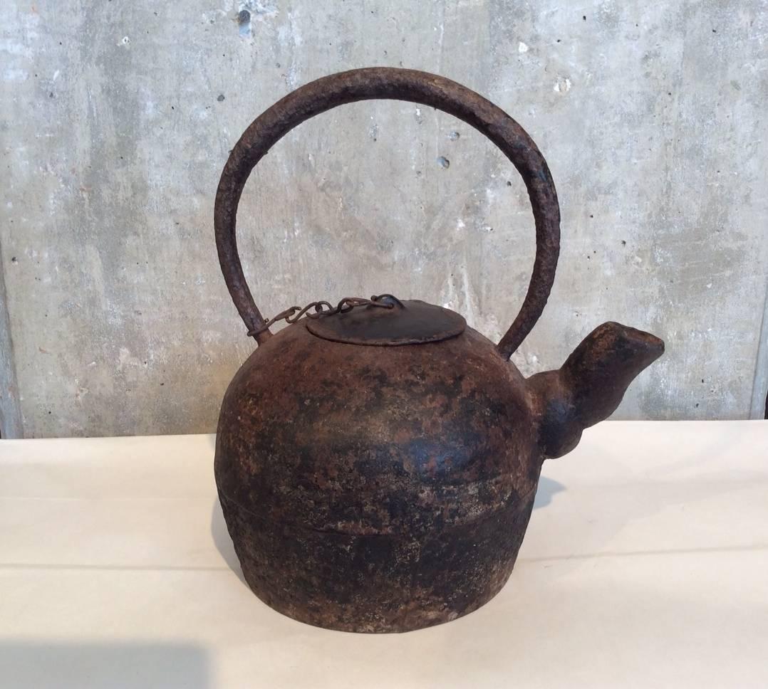 A gracefully shaped antique Chinese cast iron teapot with great patina showing traces of old lacquer. An unusually sculptural spout completes this striking piece. From Shanxi province, circa 1850.
M620.