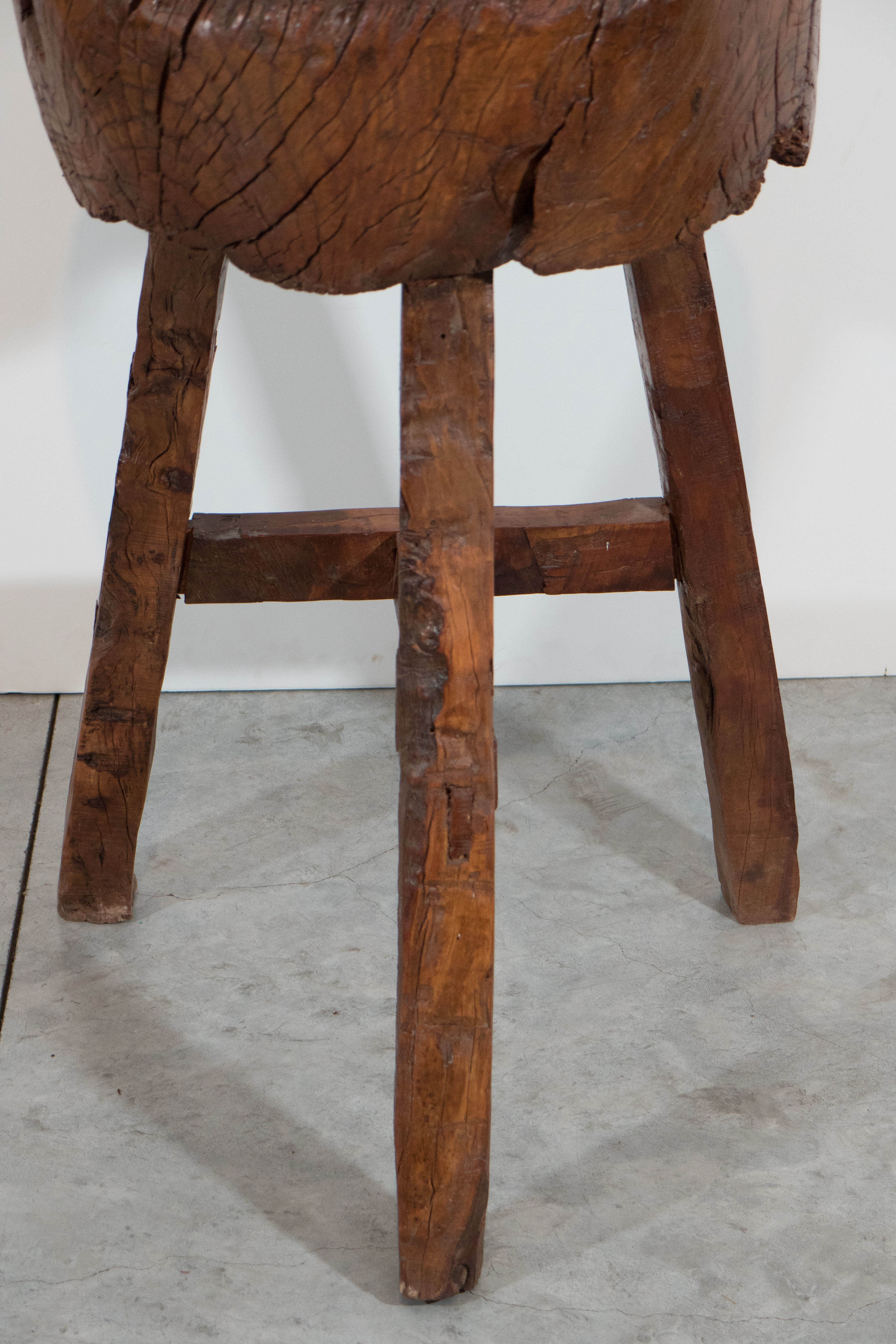 A striking, antique rustic butcher block from Shandong Province, China. Formerly used in an outdoor market, this would make an interesting stand, side table or stool.  
S345
