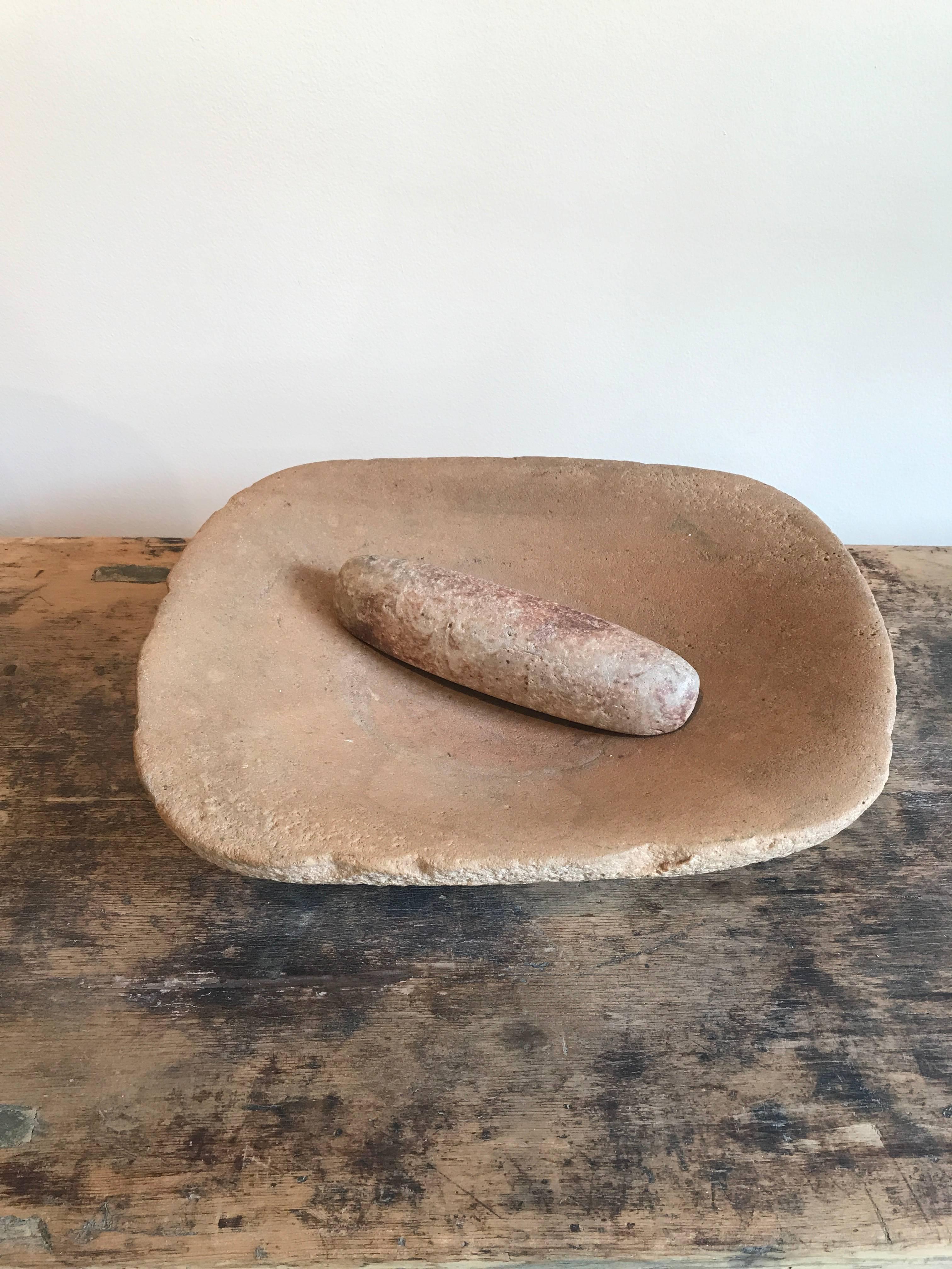 A large beautifully colored and shaped Native American stone grinding bowl with a stone pestle. This unusually large bowl has a beautiful patina and texture. 
TR146.