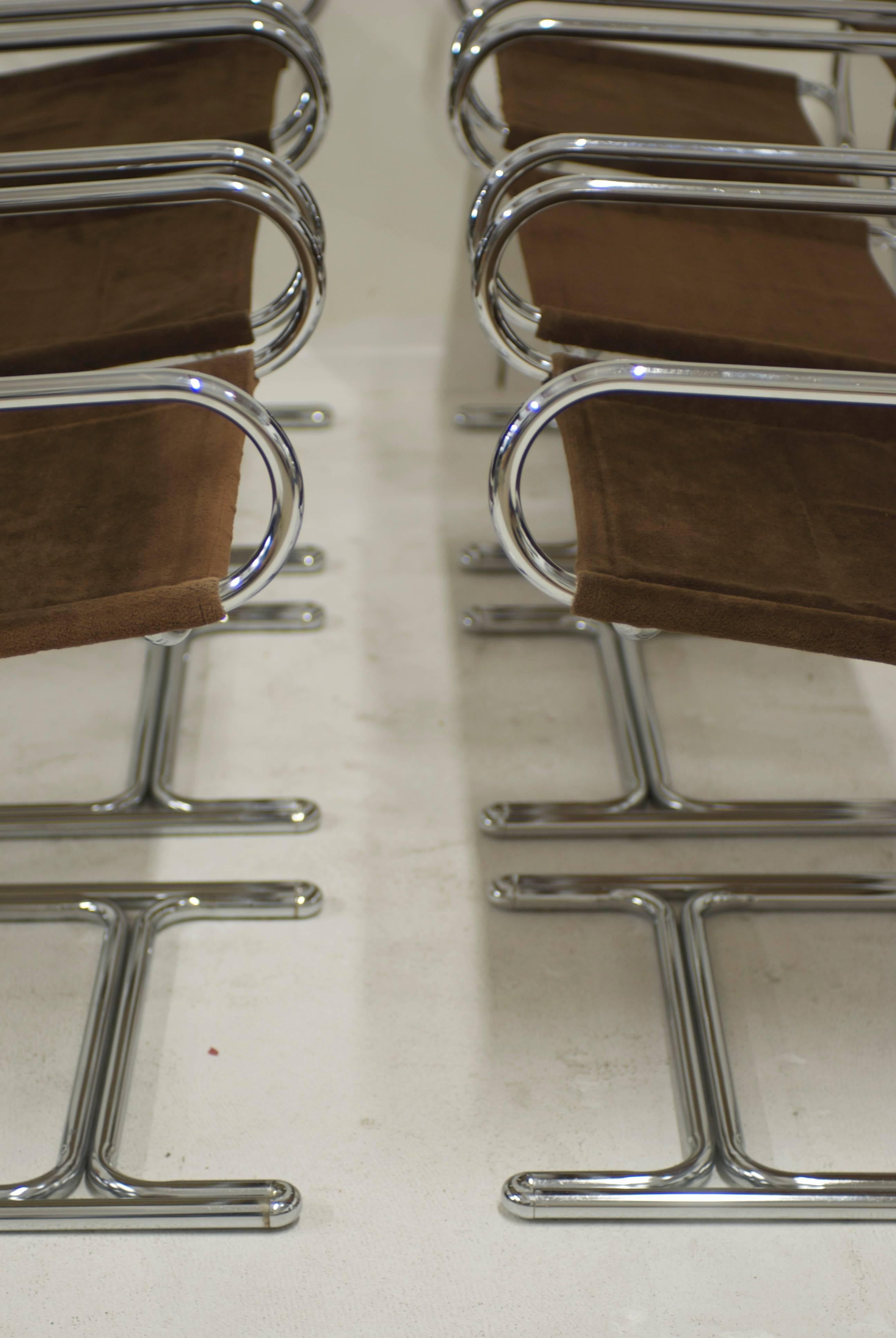 A set of six Italian dining chairs with arms. The frame is made of tubular chrome which is reminiscent of the fabrication style of Gastone Rinaldi (1920-2006) when he designed for his fathers firm RIMA and then continued on at his own firm Thema.