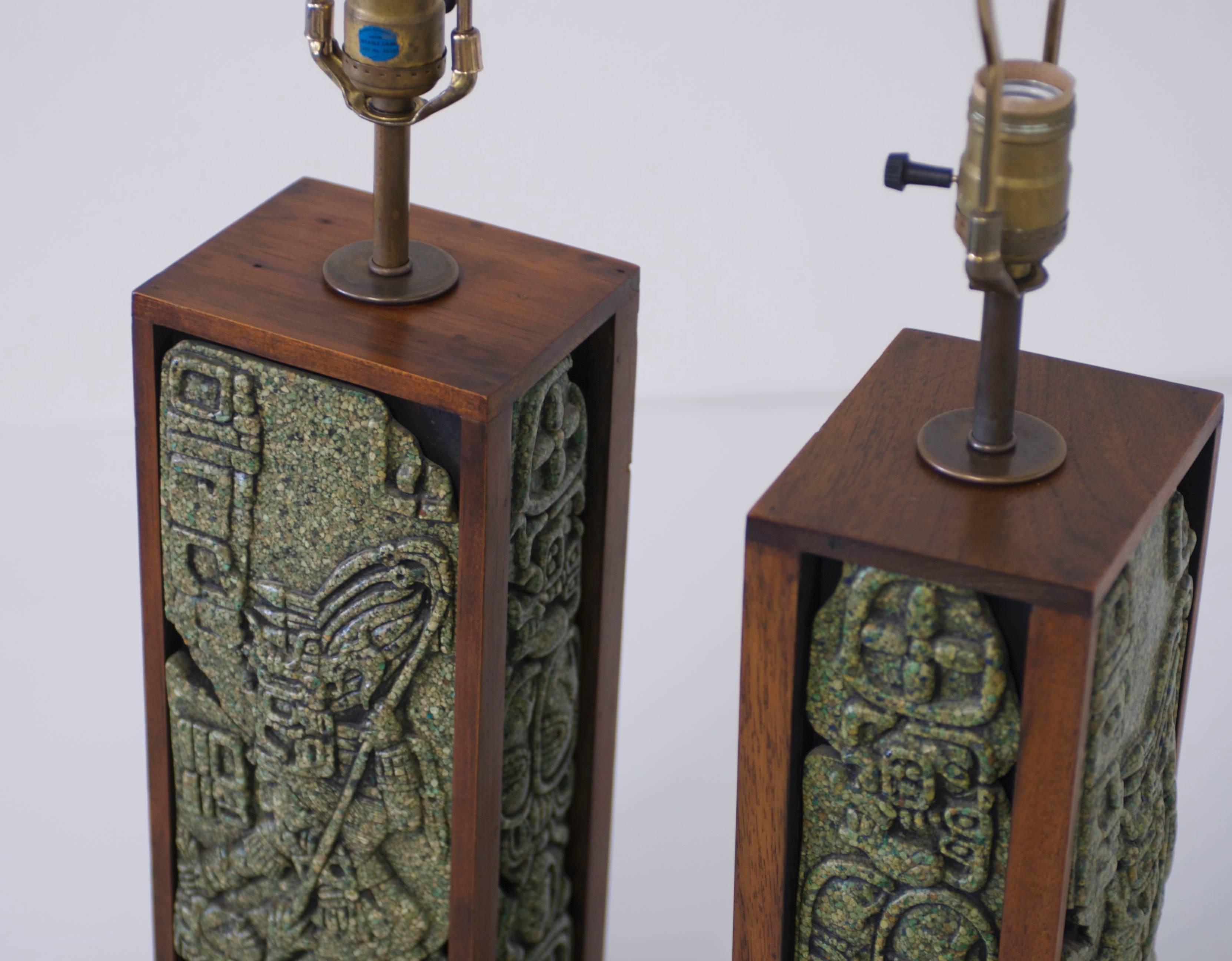 A 1960s era pair of Mexican table lamps with a Mayan motif featuring a stepped up base. The lamps are made of mahogany wood and feature Zarebski's patented malachite stone resin mix. Zarebski Industries was based in Cuernavaca, Mexico and run by