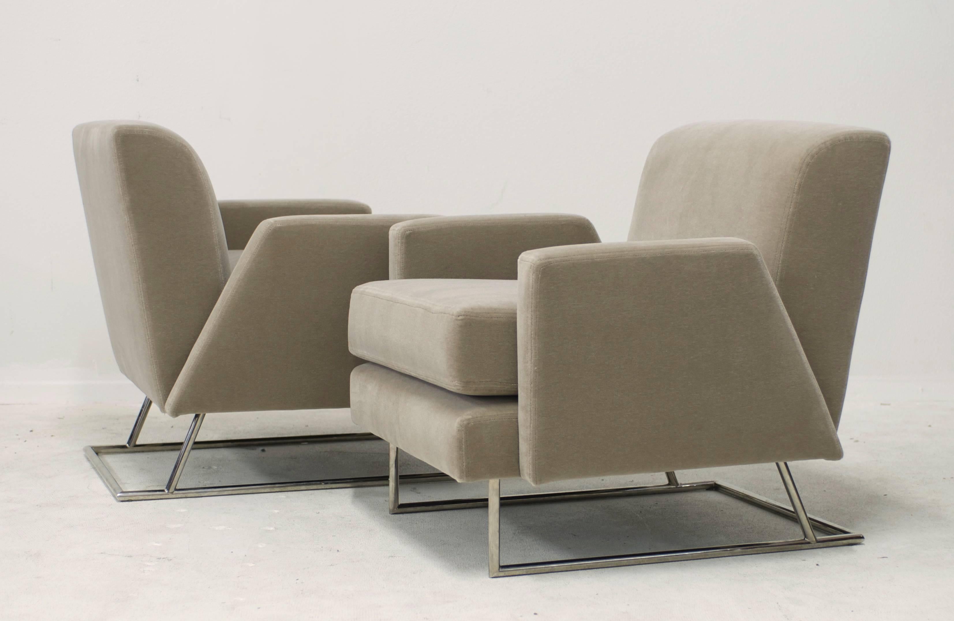 In the style of Paul Tuttle this post modern pair of lounge chairs have been reupholstered in a luxe very light sage colored mohair. It's like a champagne color with a slightest hint of olive. The polished steel bases have a nice sculptural angle at